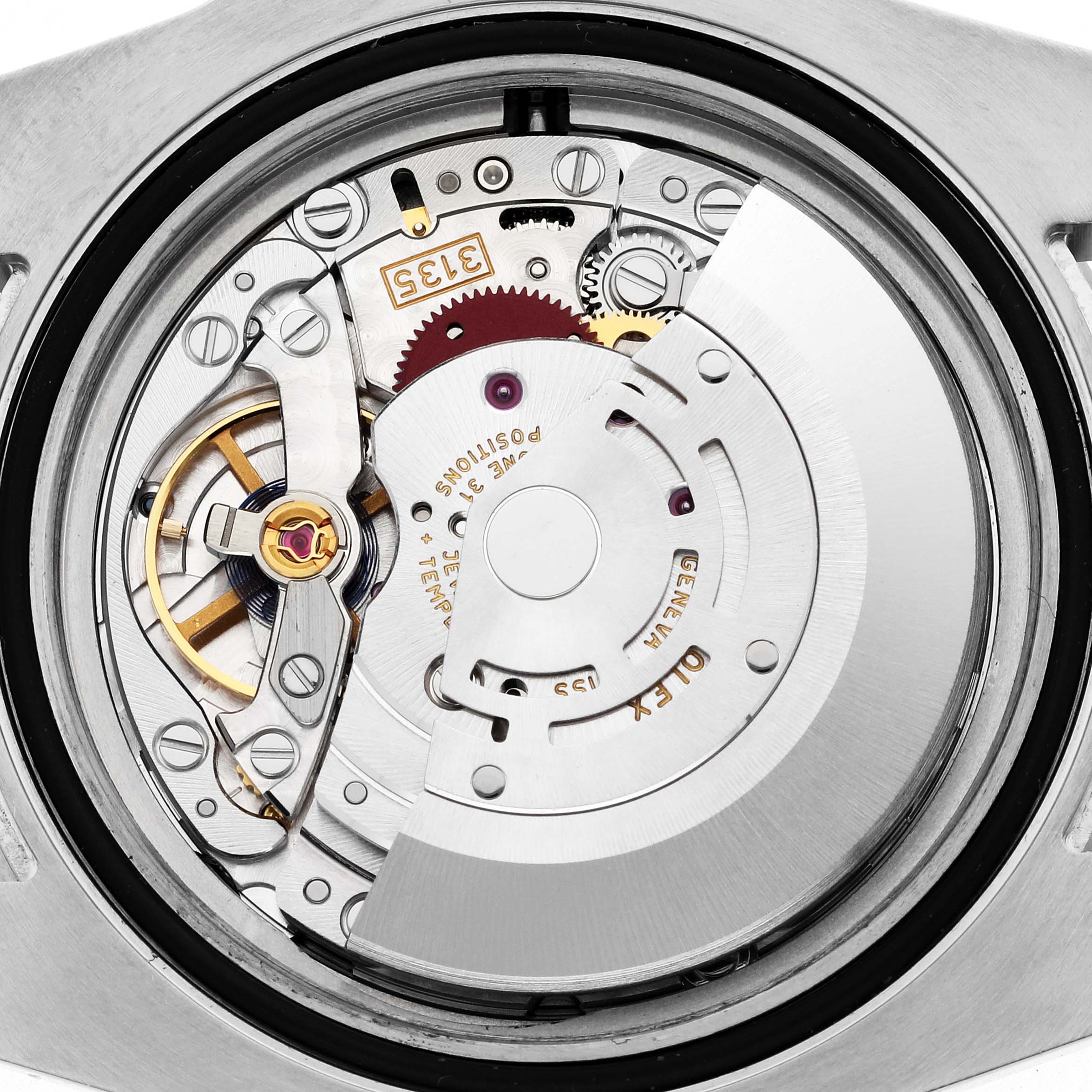 The image shows the movement mechanism of the Rolex Submariner 116610LV Men's Stainless Steel Green Dial 116610LV Men's Stainless Steel Green Dial watch from a back view, highlighting gears and components.