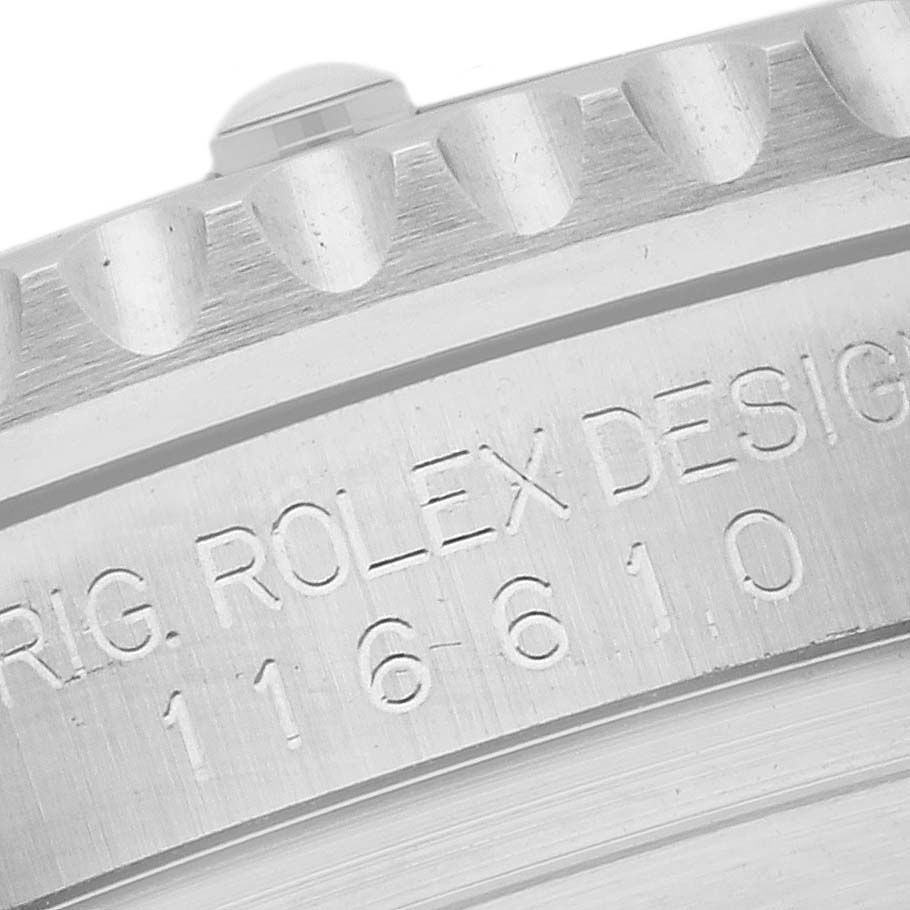 The image shows a close-up of the side of a Rolex Submariner 116610LV Men's Stainless Steel Green Dial 116610LV Men's Stainless Steel Green Dial watch case with engraved text and part of the bezel.