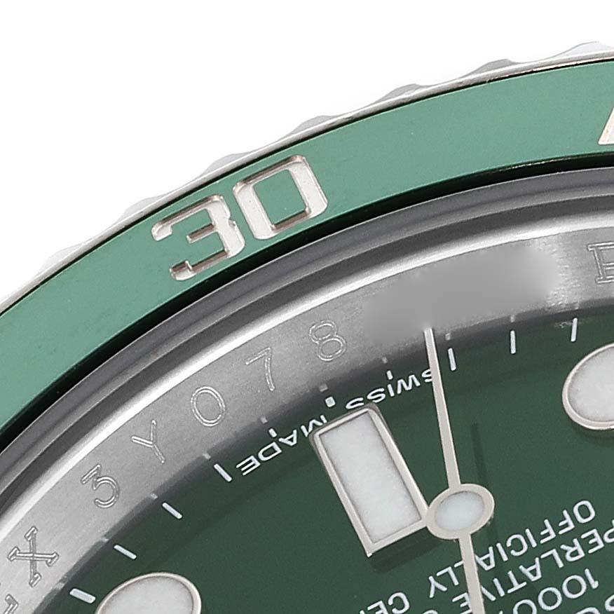 This close-up image shows the bezel and part of the dial of a Rolex Submariner 116610LV Men's Stainless Steel Green Dial 116610LV Men's Stainless Steel Green Dial watch with a green bezel and dial.