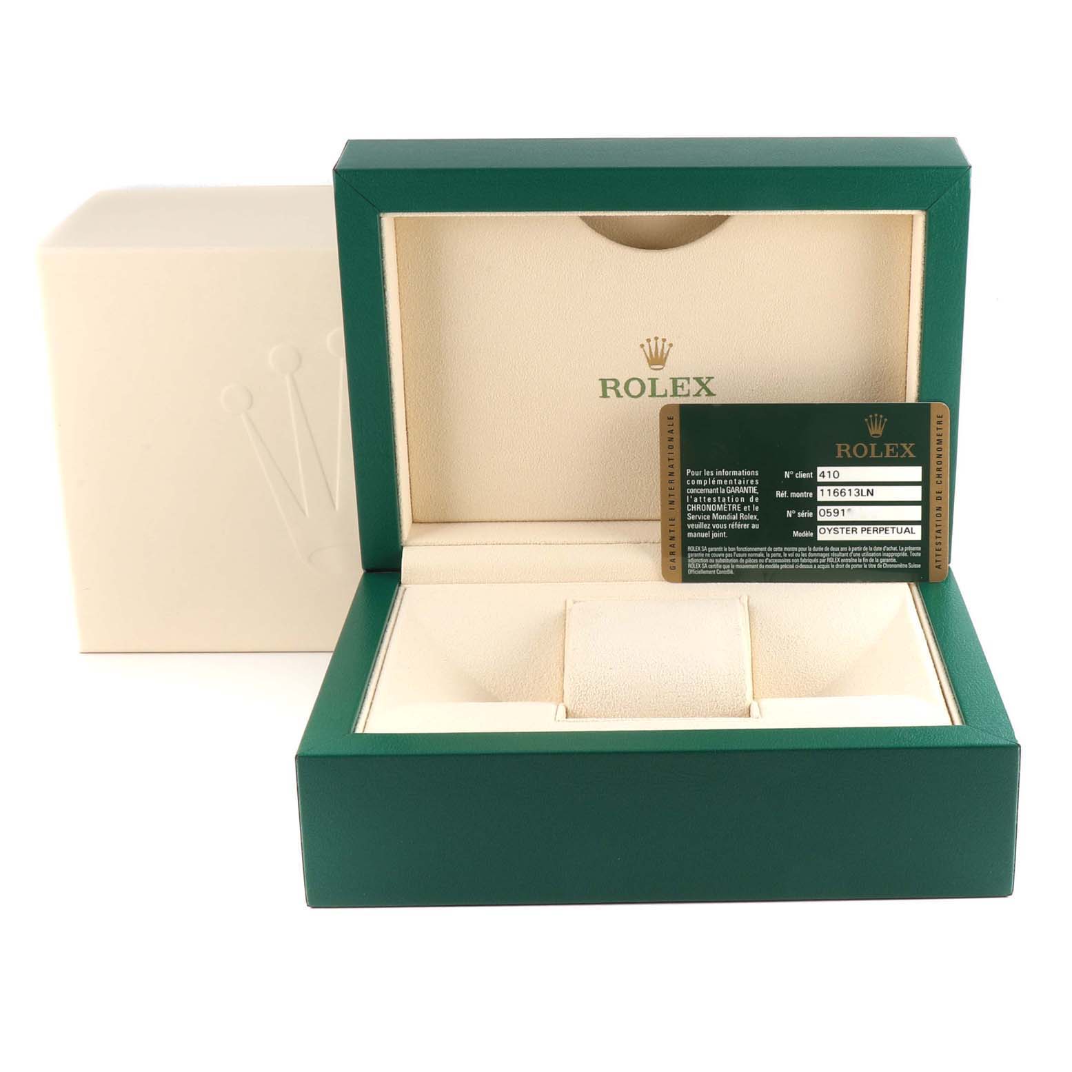 The image shows an empty green Rolex Submariner 116613LN Men
s Steel and Gold (two tone) Black Dial 116613LN Men
s Steel and Gold (two tone) Black Dial watch box with a warranty card displayed inside.