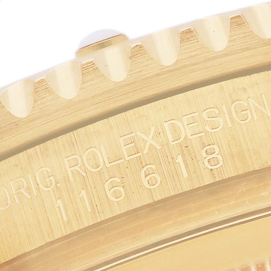 The image shows the side view of the Rolex Submariner 116618LB Men's Yellow Gold Blue Dial 116618LB Men's Yellow Gold Blue Dial's bezel and casing, highlighting the engraved model number and brand.