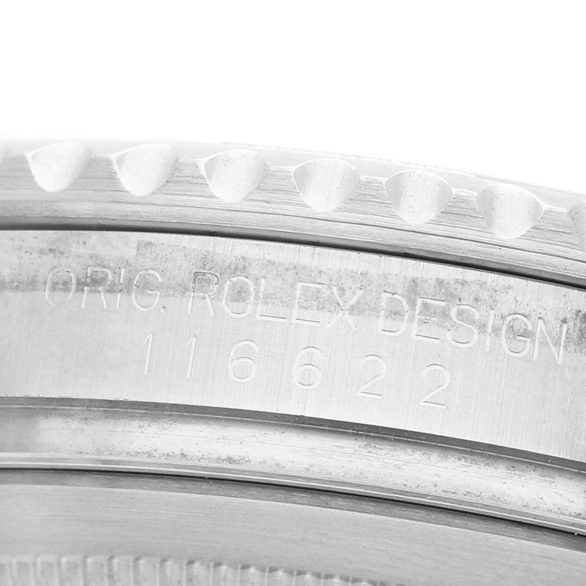 The image shows a close-up of the Rolex Yacht-Master 116622 Men's Stainless Steel Silver Dial's engraved outer bezel and case reference number.