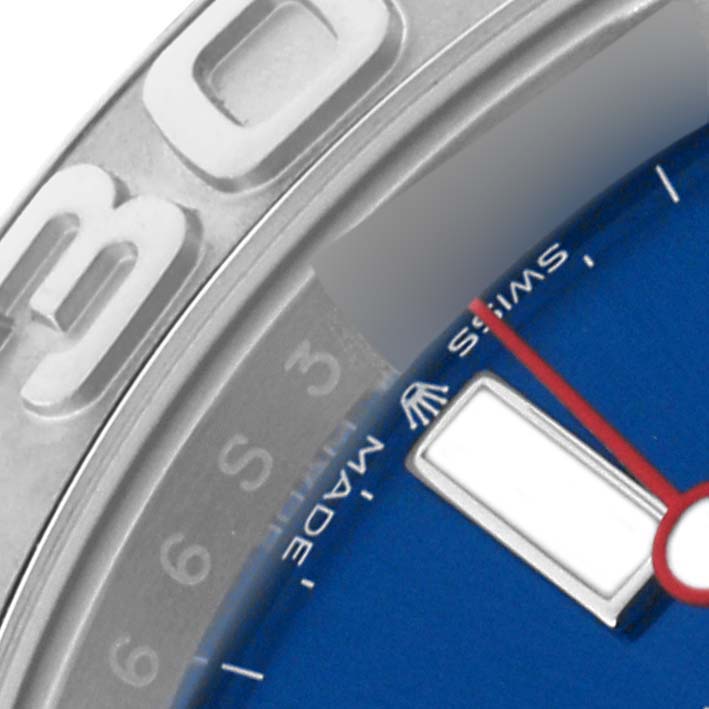 The image shows a close-up of the Rolex Yacht-Master 126622 Men's Stainless Steel Blue Dial 126622 Men's Stainless Steel Blue Dial, highlighting part of the bezel and the blue dial with a red second hand.
