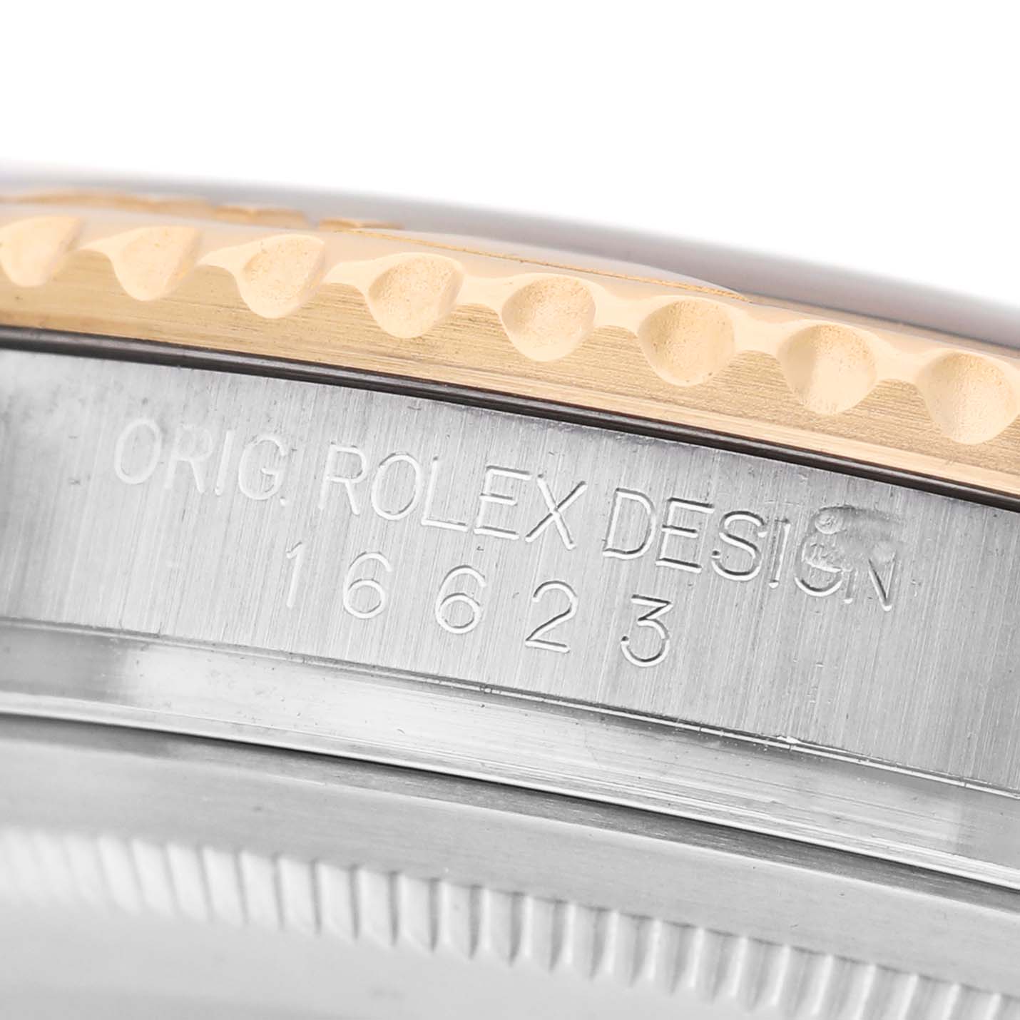 The image shows a close-up angle of the Rolex Yacht-Master 16623 Men's Steel and Gold (two tone) White Dial's bezel and serial engravings.