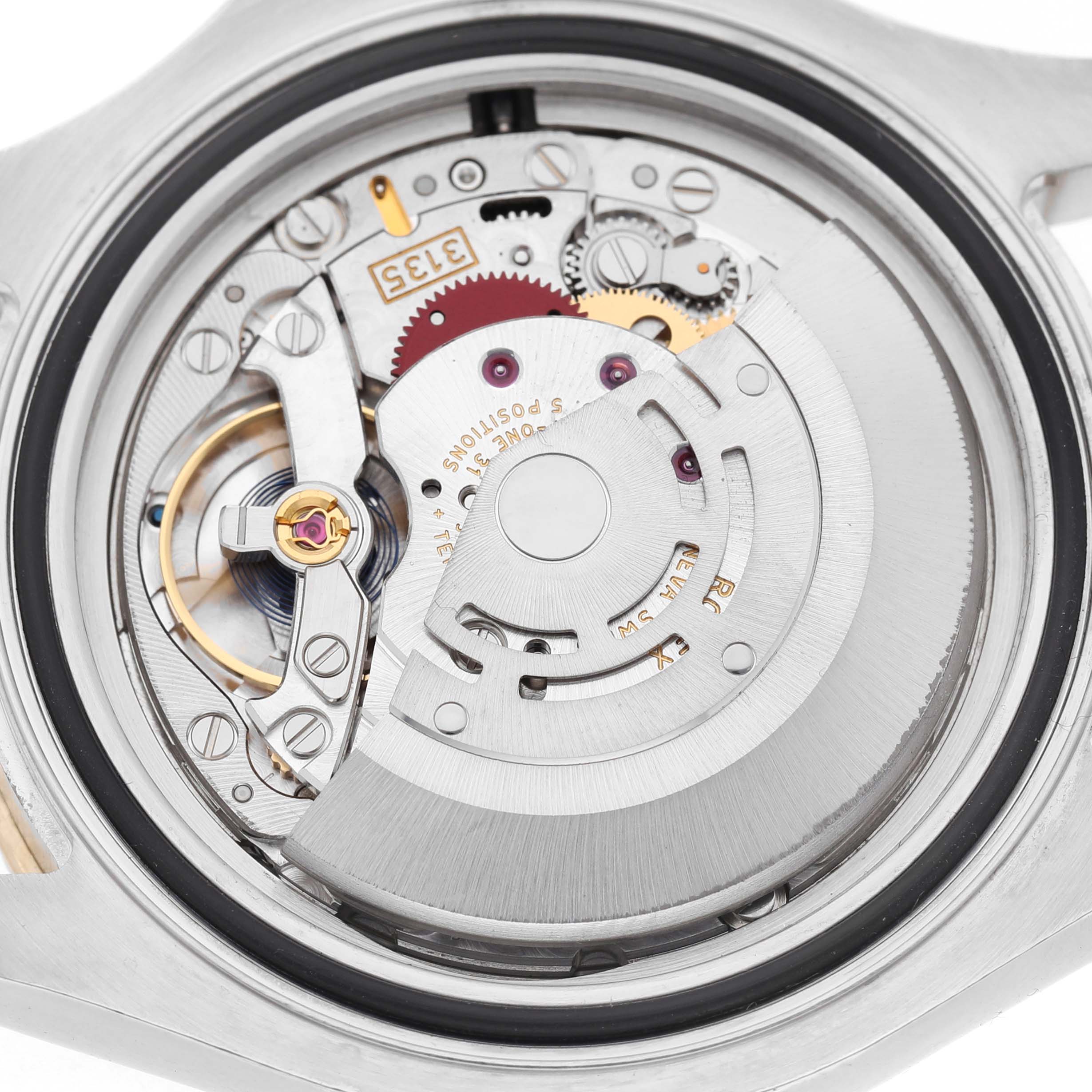 The image shows the movement of a Rolex Yacht-Master 16623 Men's Steel and Gold (two tone) White Dial watch viewed from the back, highlighting its intricate gears and rotor.