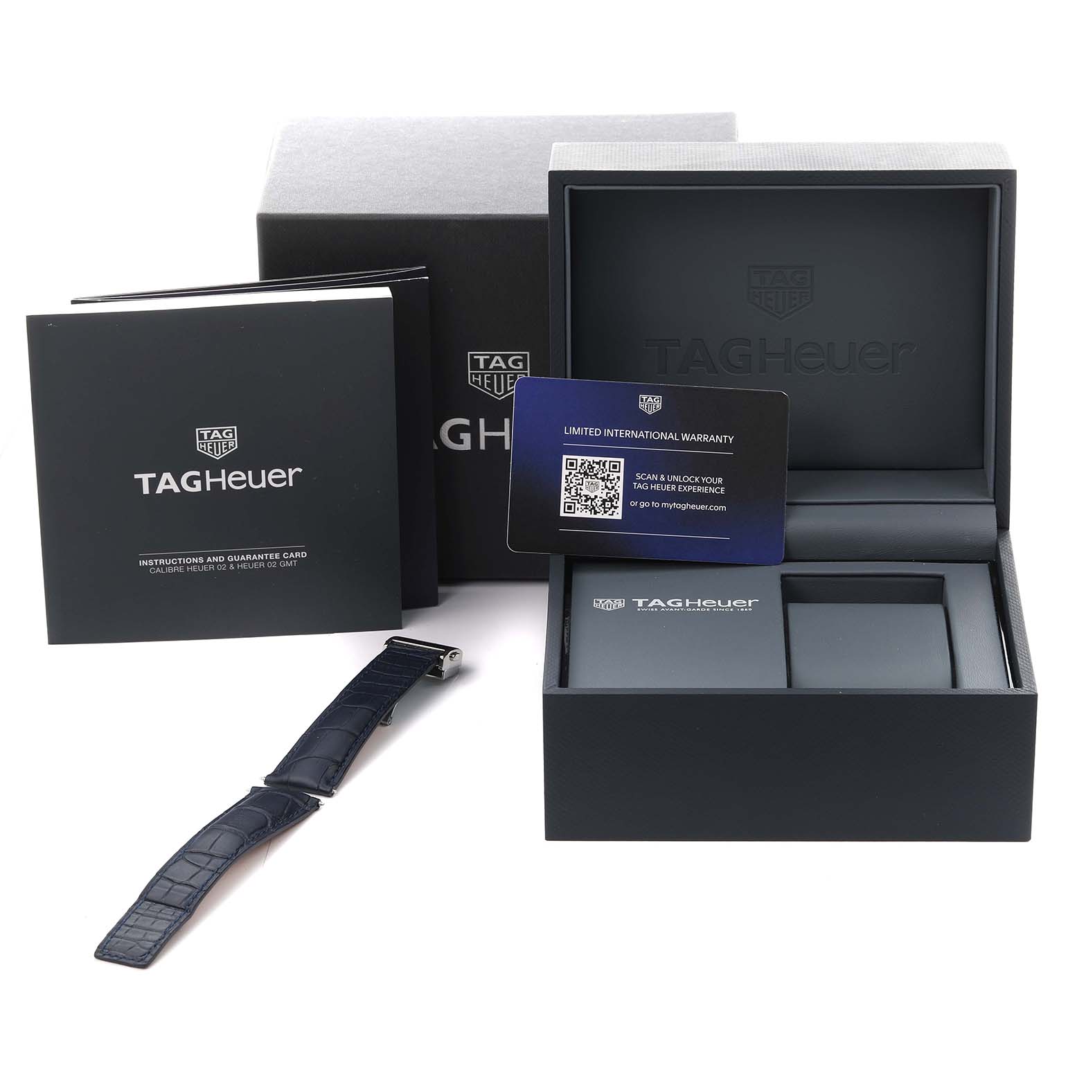 The image shows a Tag Heuer Monaco CBL2111.BA0644 Men's Stainless Steel Blue Dial CBL2111.BA0644 Men's Stainless Steel Blue Dial watch box, instruction booklet, warranty card, and a watch strap from a frontal angle.