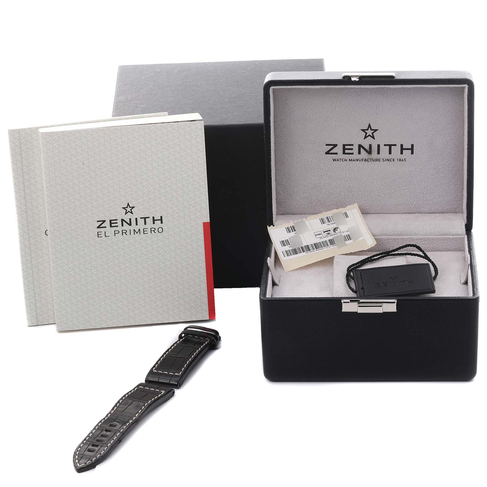 The image shows a Zenith Pilot 03.2430.4054/21.C721 Men's Stainless Steel Black Dial 03.2430.4054/21.C721 Men's Stainless Steel Black Dial watch's packaging, including the box, extra strap, manual, and tag from a front view.