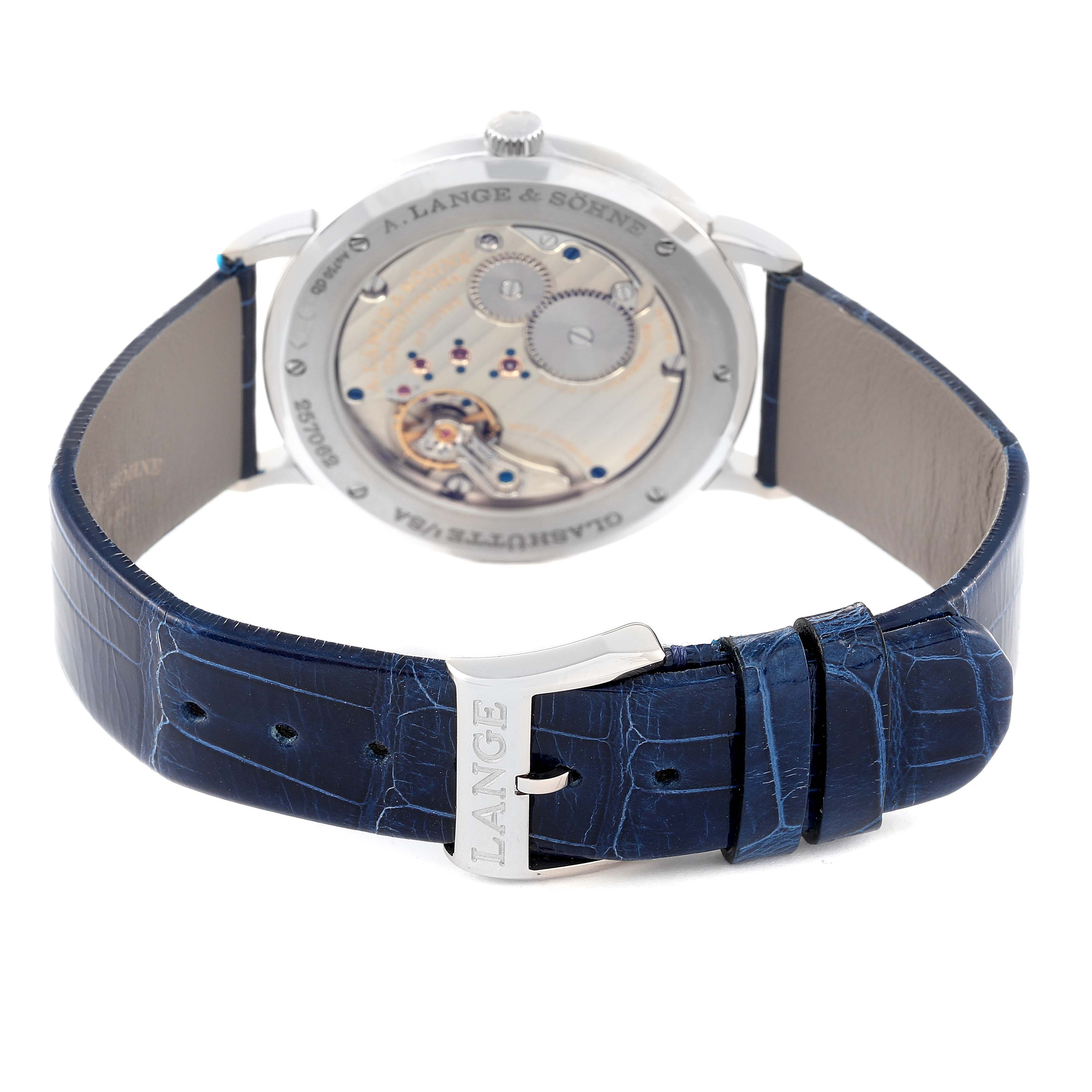 The image shows the back view of the Saxonia model by A. Lange & Söhne, highlighting the movement and blue strap with buckle.