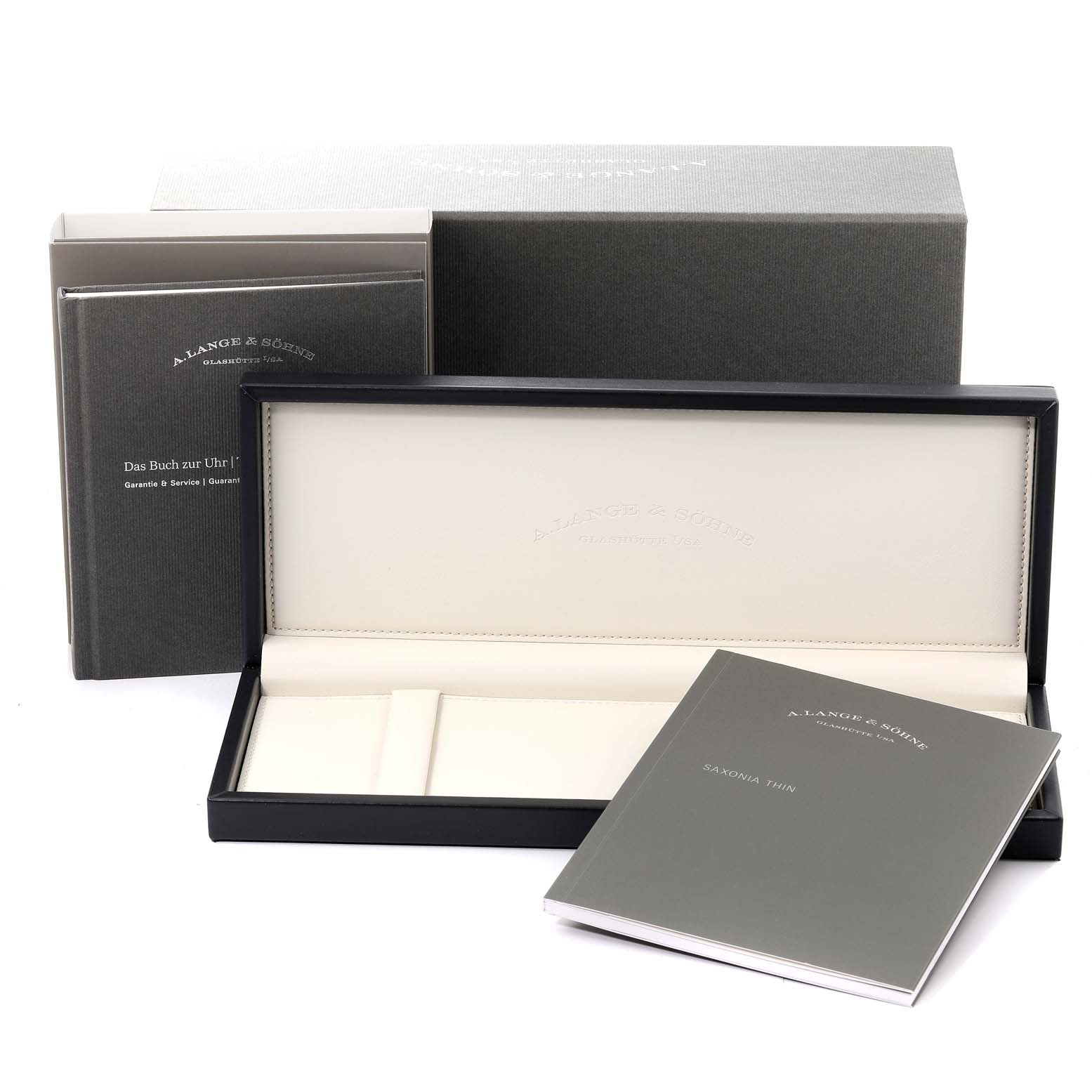 The image shows the packaging box, a watch case, and instruction manual for the A. Lange & Sohne Saxonia 205.086 / LSLS2053AX Men's White Gold Blue Dial model.