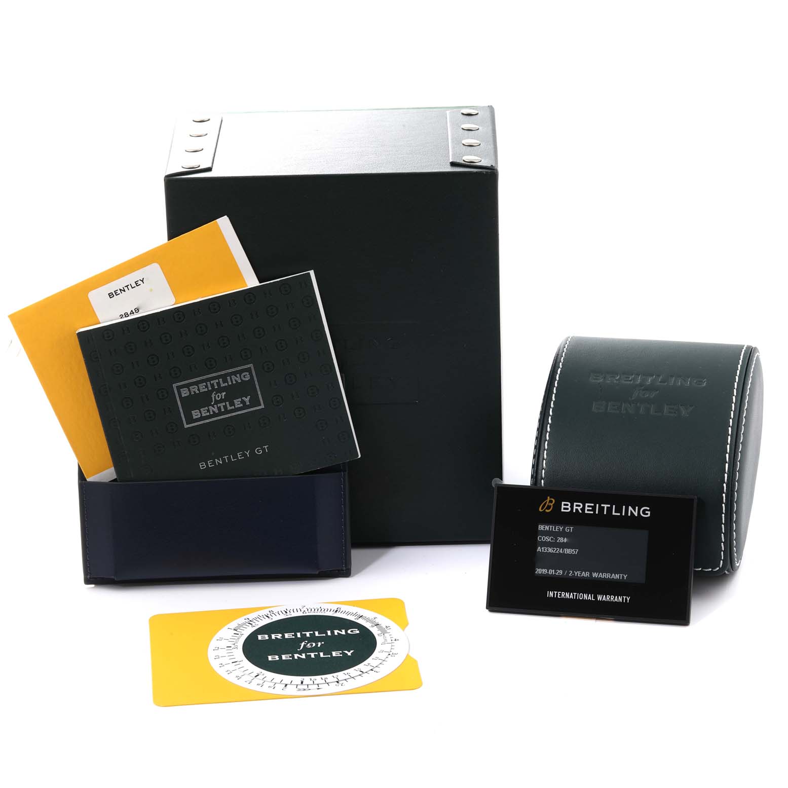 The image shows the packaging and accessories for a Bentley model by Breitling, including manuals, a warranty card, and a watch case.