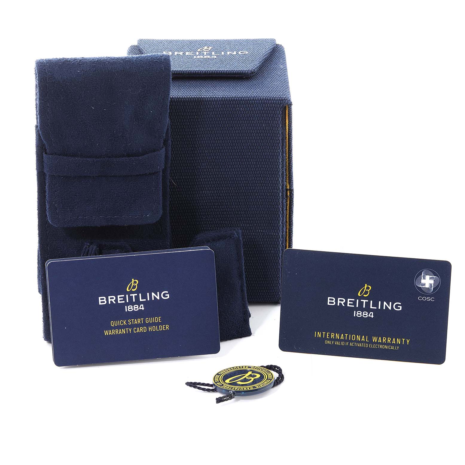 The image shows the accessories of a Breitling Superocean A17366 Men's Stainless Steel White Dial A17366 Men's Stainless Steel White Dial watch, including the box, warranty cards, a pouch, and a tag.