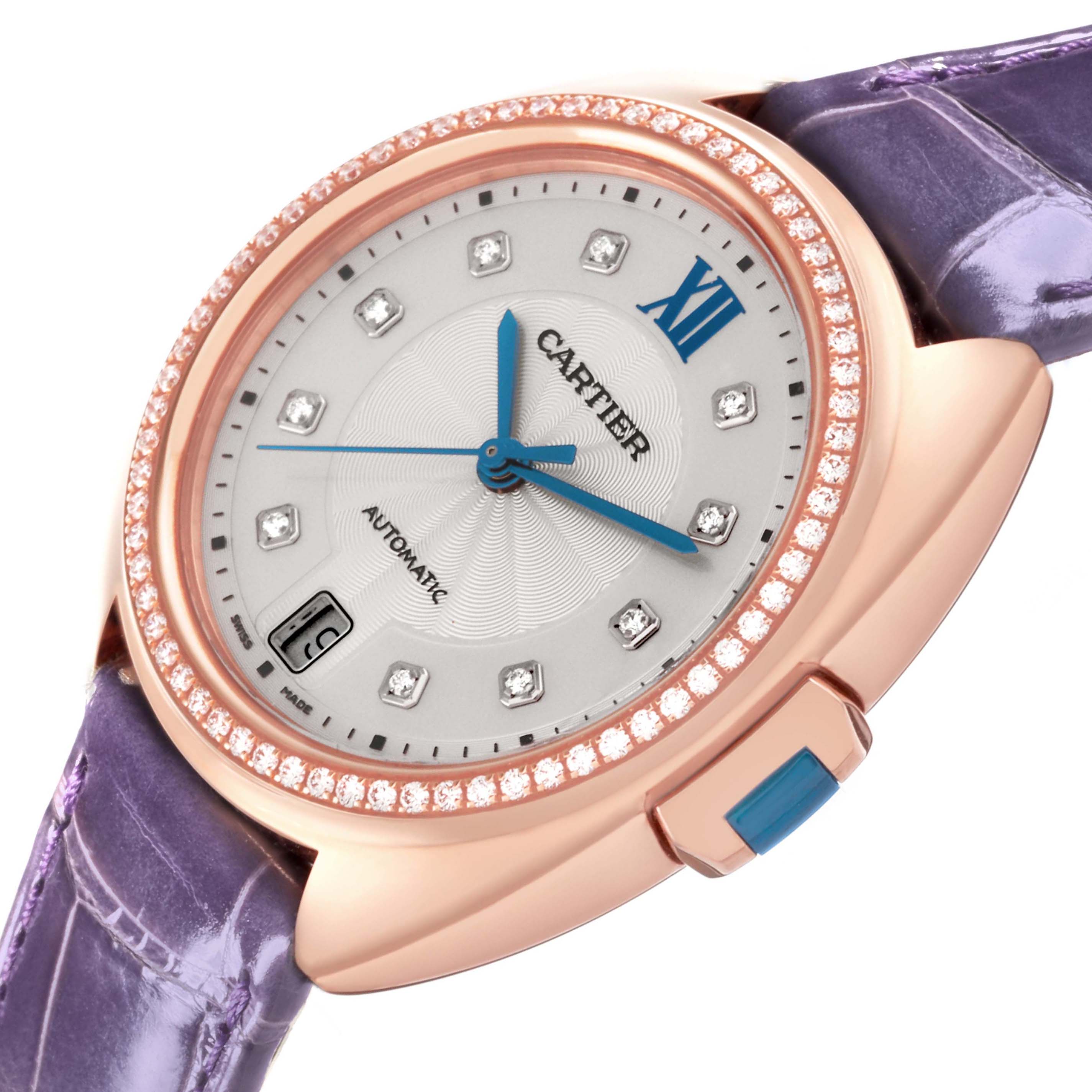 The Cartier Clé watch is shown from an angled perspective highlighting the bezel, dial, and purple strap.