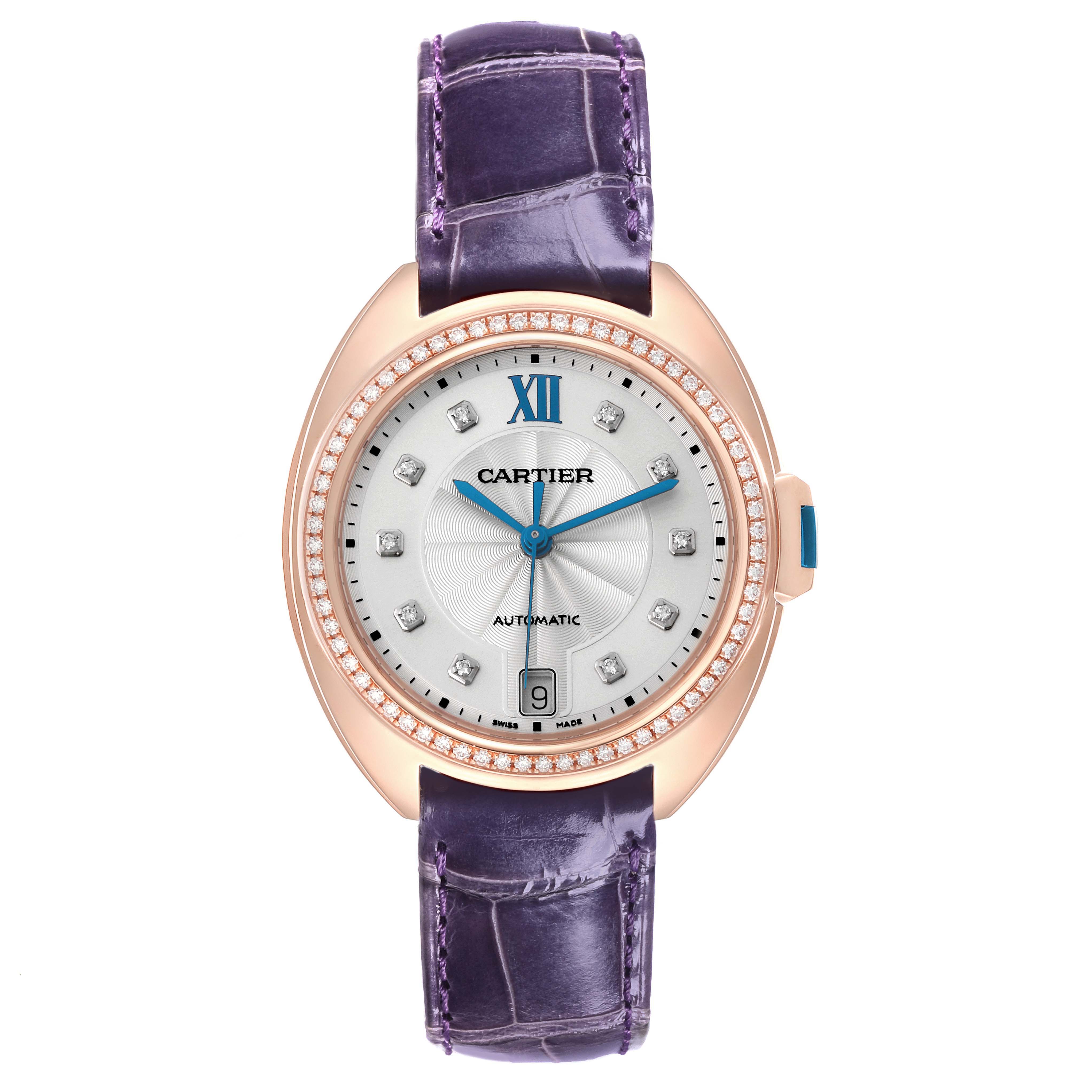 The Cartier Clé watch is shown from a top view, highlighting its dial, purple strap, and diamond-set rose gold bezel.