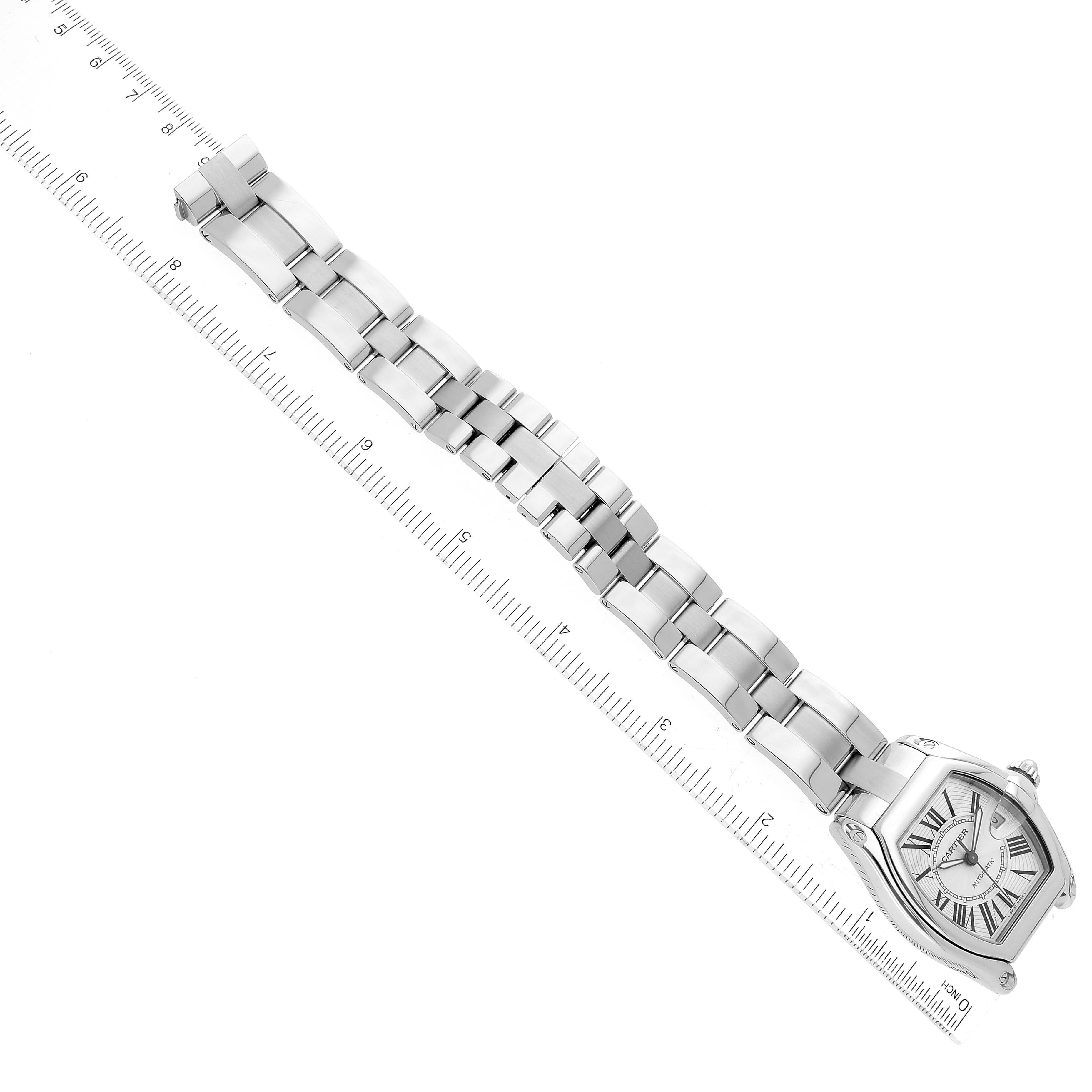 The Cartier Roadster W62025V3 Men's Stainless Steel Silver Dial W62025V3 Men's Stainless Steel Silver Dial watch is displayed flat with its full bracelet and part of a ruler for scale.