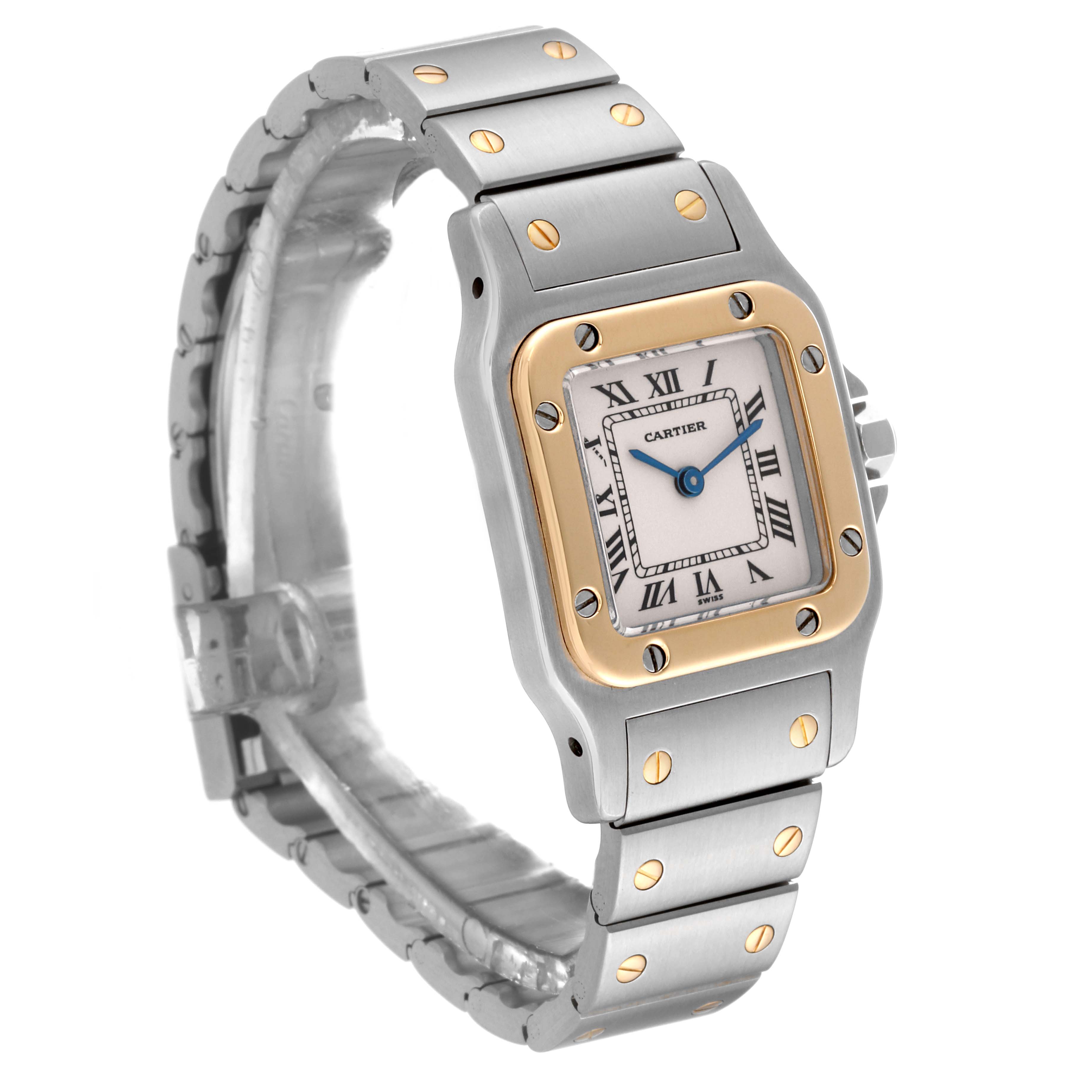 This image showcases a side angle of the Cartier Santos W20012C4 Women's Steel and Gold (two tone) Silver Dial W20012C4 Women's Steel and Gold (two tone) Silver Dial watch, featuring its face, bezel, and metal bracelet.