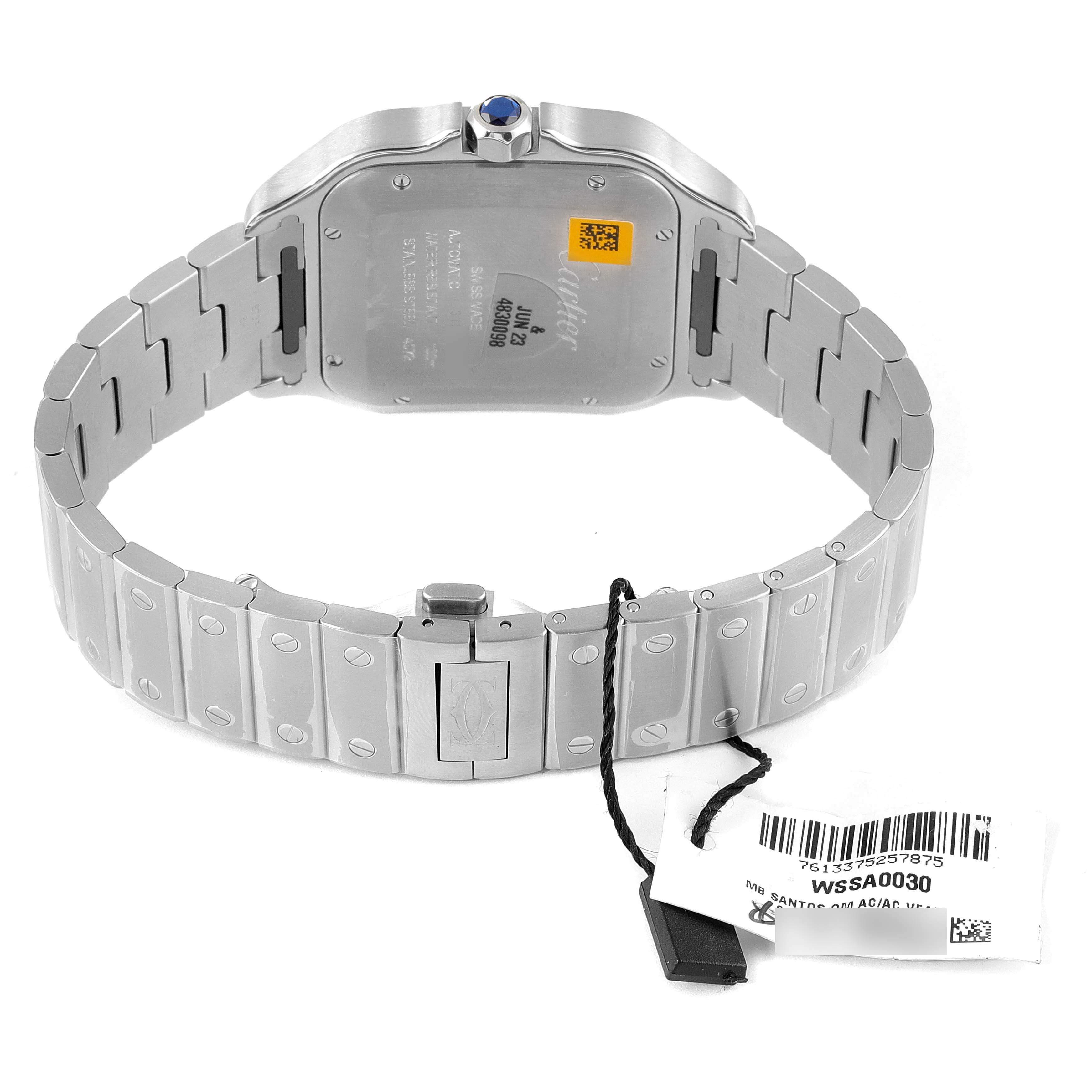 The image shows the back view of a Santos model watch by Cartier, highlighting its case back, bracelet, and crown.