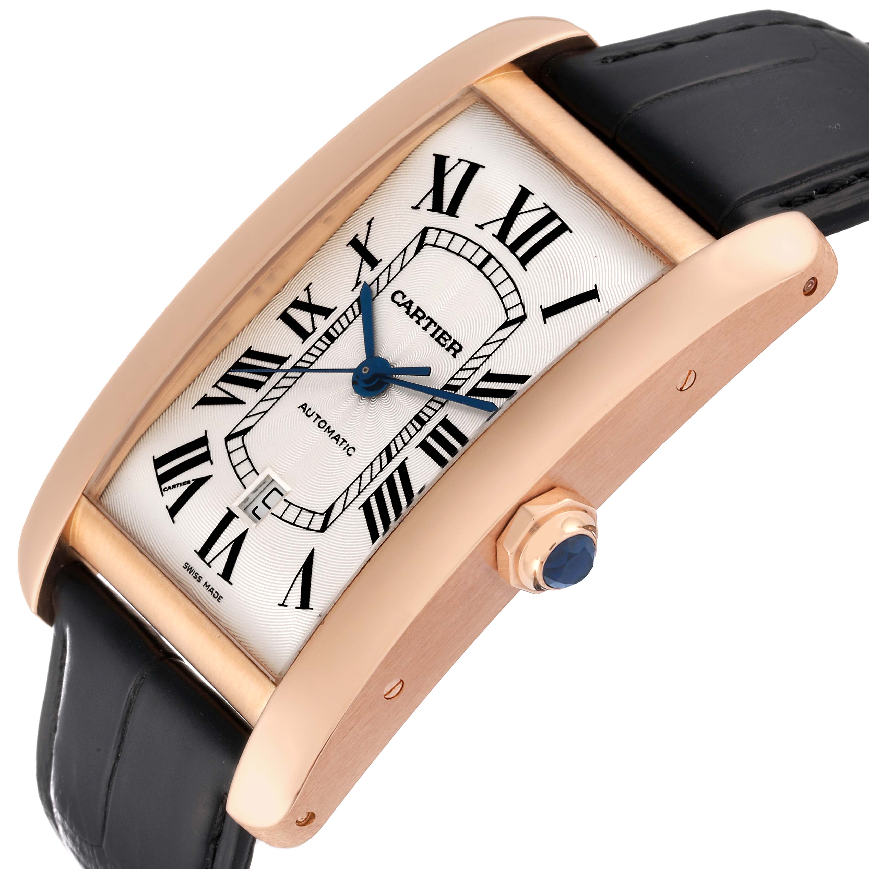 The image shows a Cartier Tank Americaine W2609856 Men
s Rose Gold Silver Dial W2609856 Men
s Rose Gold Silver Dial watch at an oblique angle, highlighting its Roman numeral dial, blue hands, crown, and leather strap.
