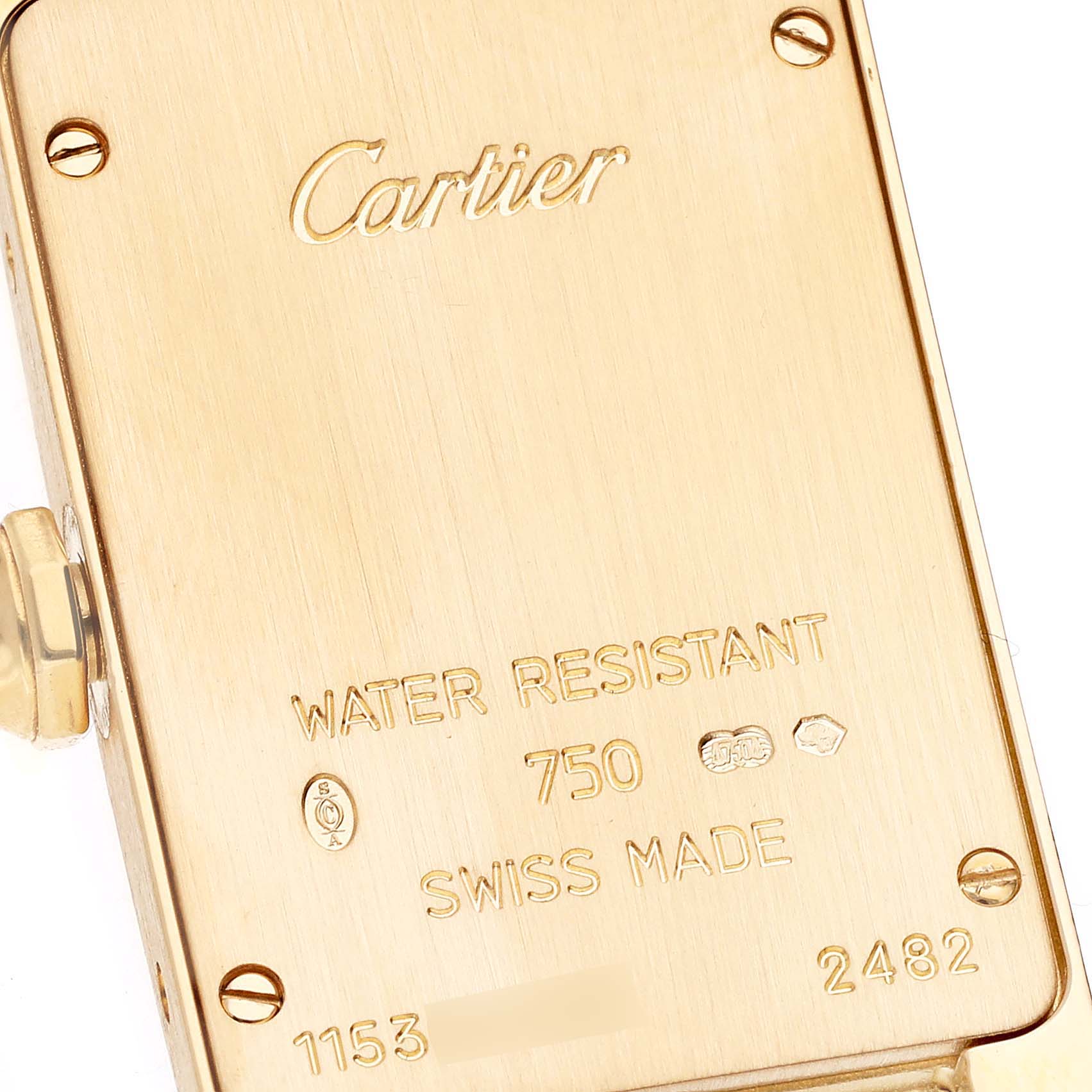 This image shows the back case of the Tank Américaine watch by Cartier at a close-up angle, highlighting engravings and markings.