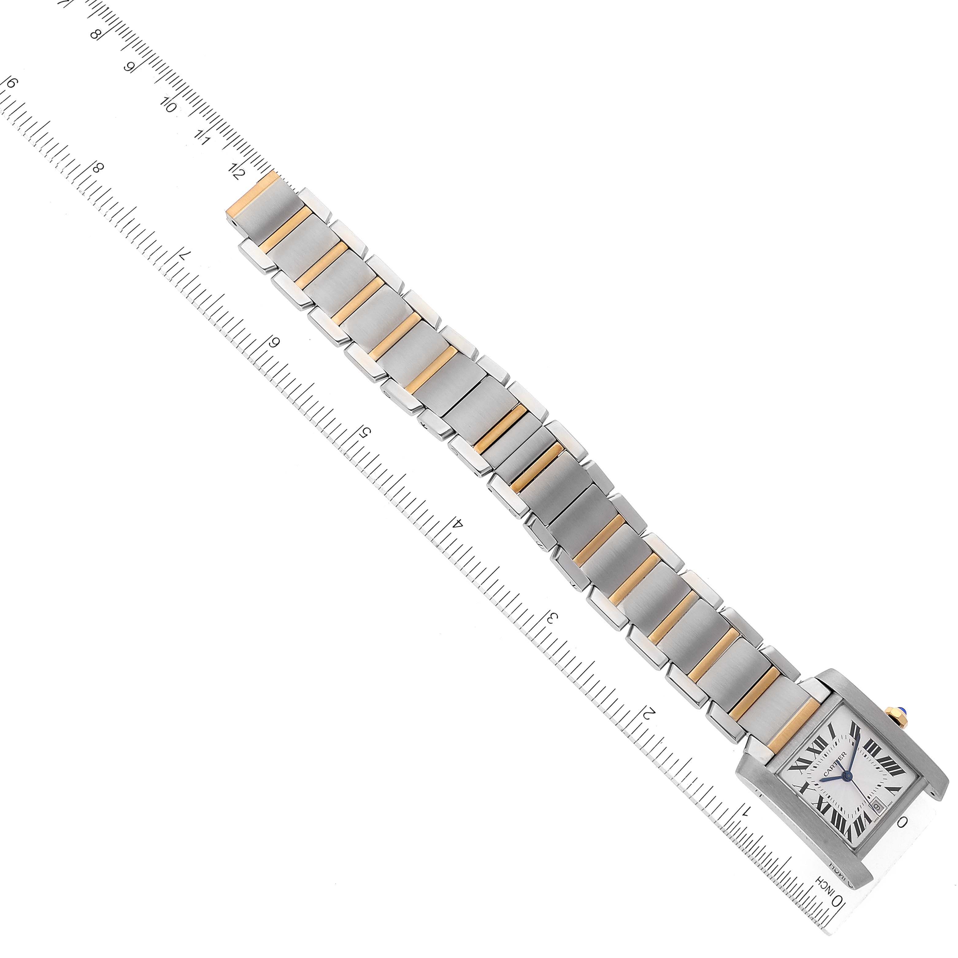 The image shows a Cartier Tank Française watch in a top-down view, displaying the face and the entire bracelet against a ruler for scale.
