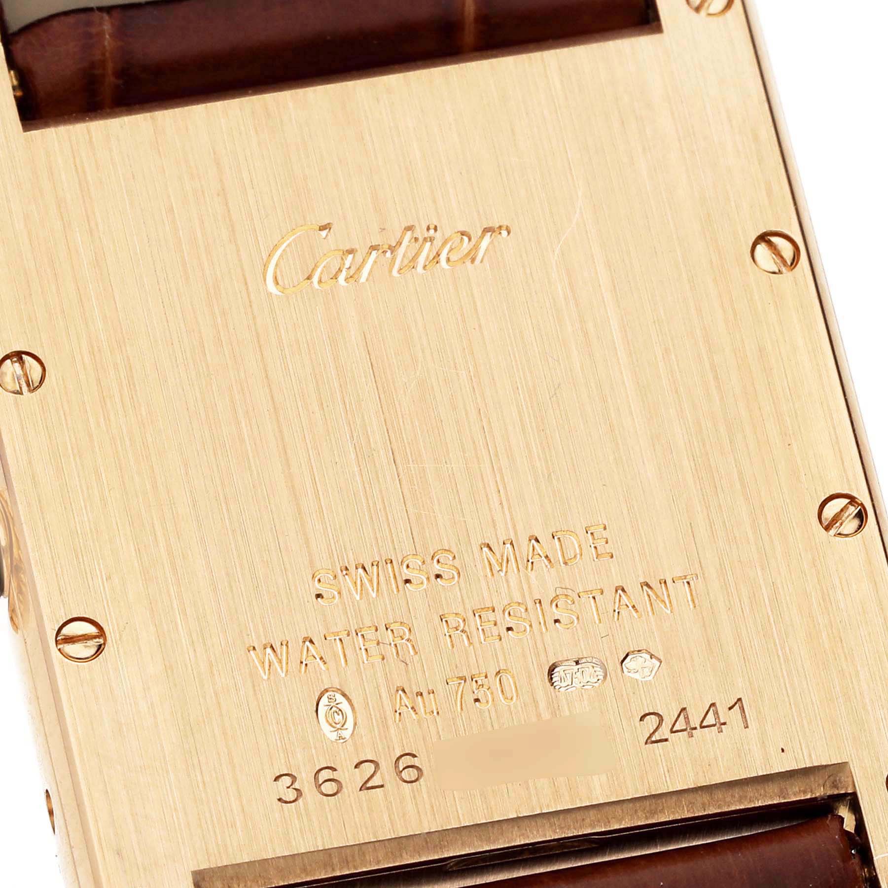This image shows the back casing of a Cartier Tank Louis W1529756 Men's Yellow Gold Silver Dial W1529756 Men's Yellow Gold Silver Dial watch, highlighting its engravings and screws.