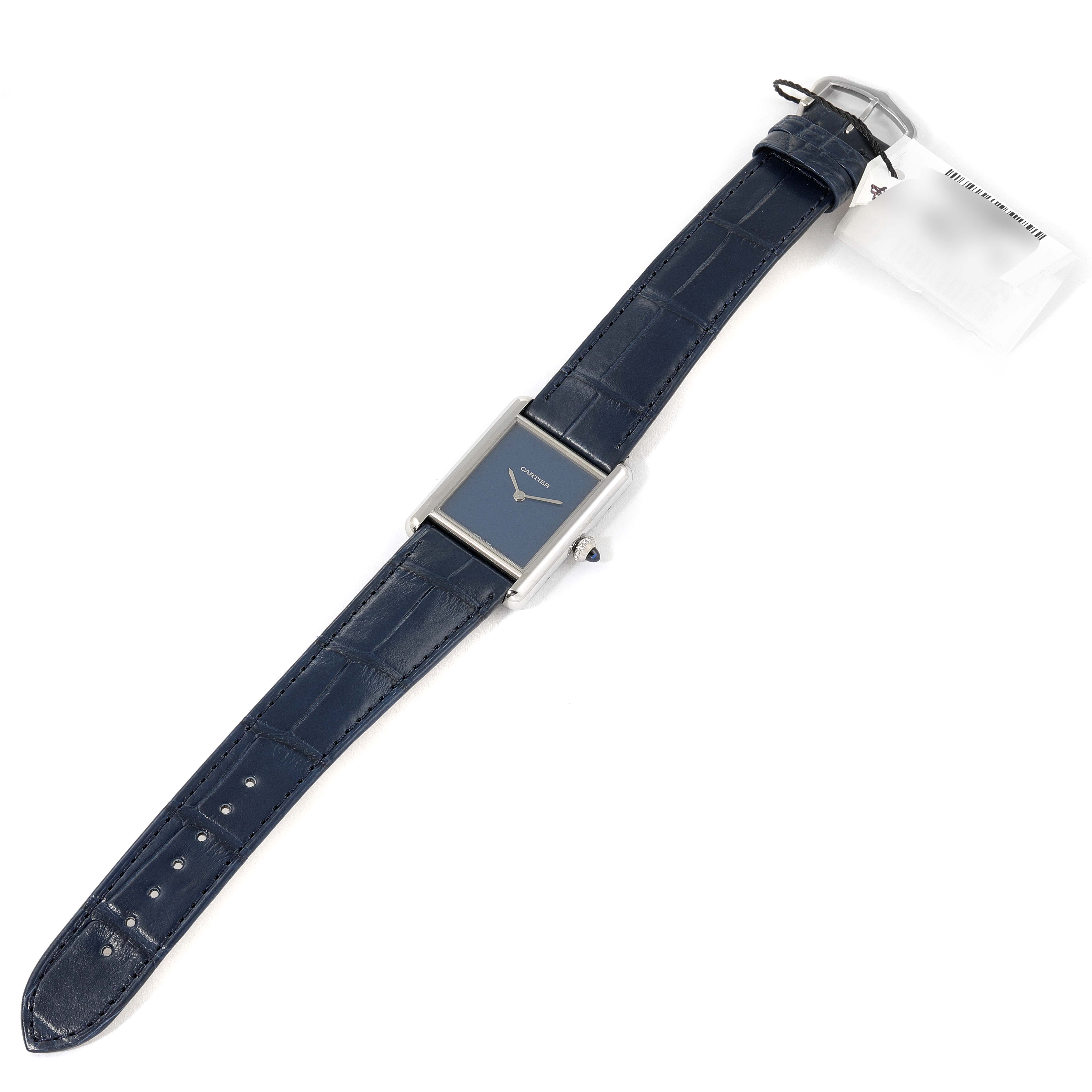 The image shows a Cartier Tank Must WSTA0055 Women's Stainless Steel Blue Dial WSTA0055 Women's Stainless Steel Blue Dial model watch with a rectangular case and blue leather strap, viewed from an angled top-down perspective.