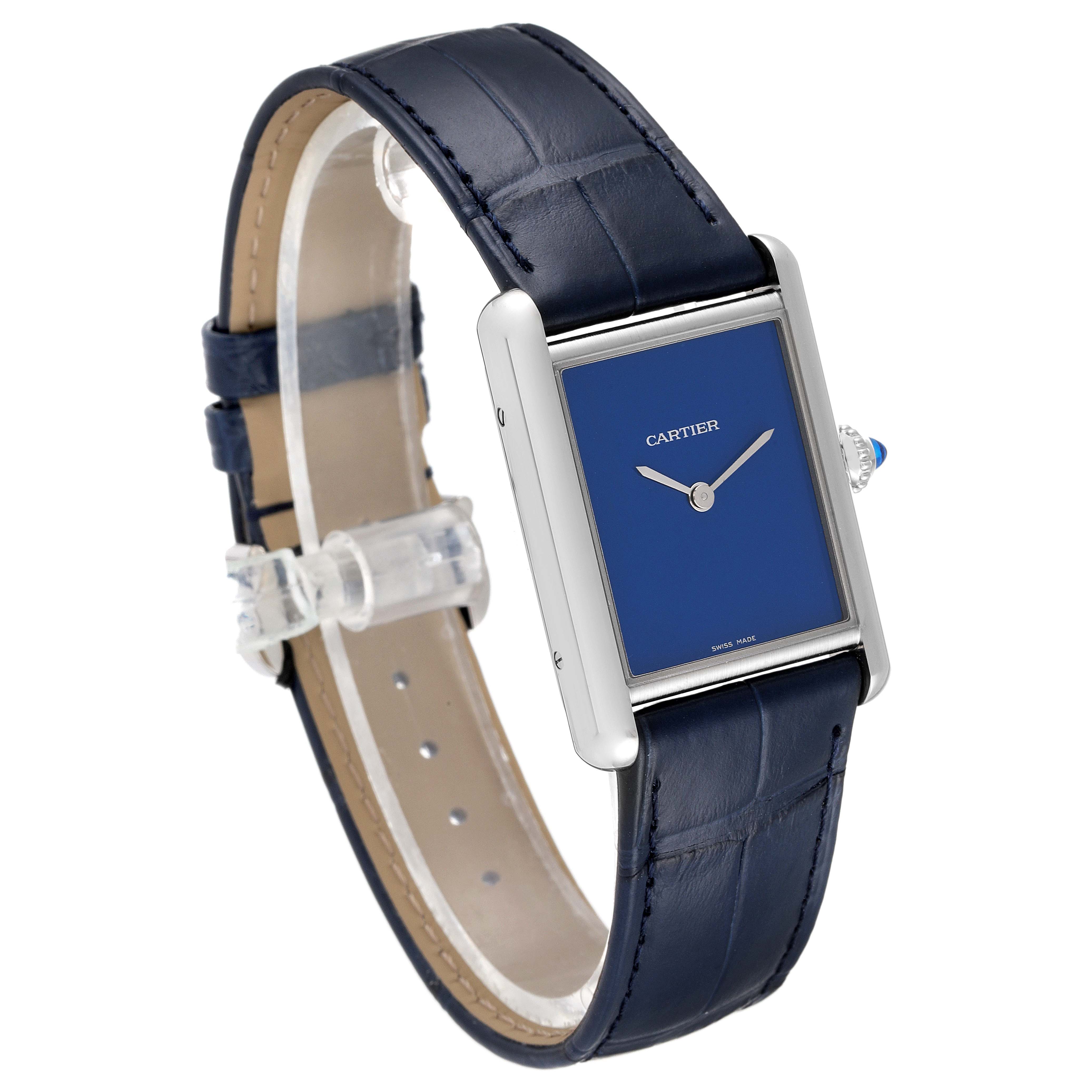 The image shows a side angle of the Cartier Tank Must WSTA0055 Women's Stainless Steel Blue Dial WSTA0055 Women's Stainless Steel Blue Dial watch, highlighting its blue face, silver case, and blue leather strap.