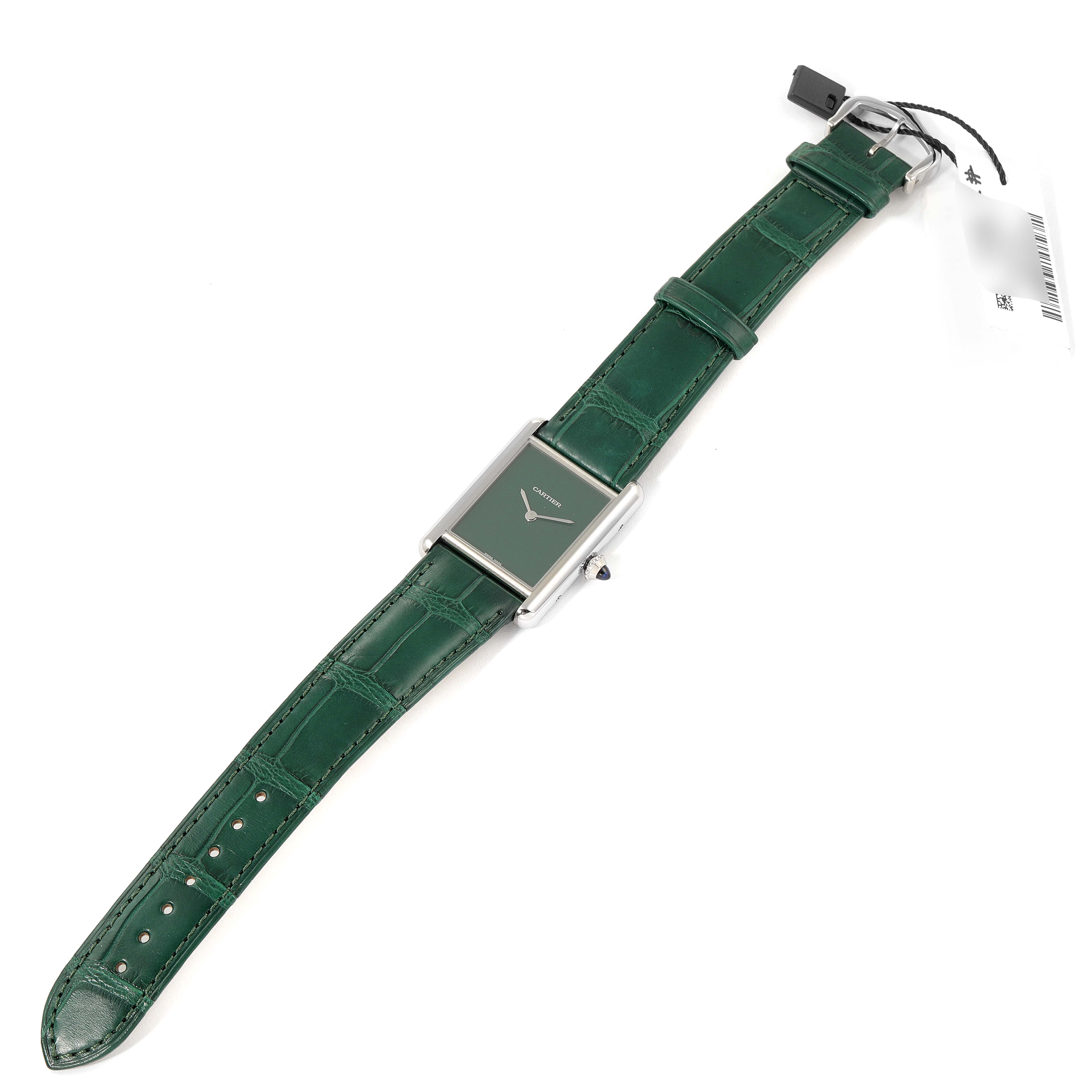 The image shows a top-down view of a Tank Must model by Cartier with a green strap and green dial.