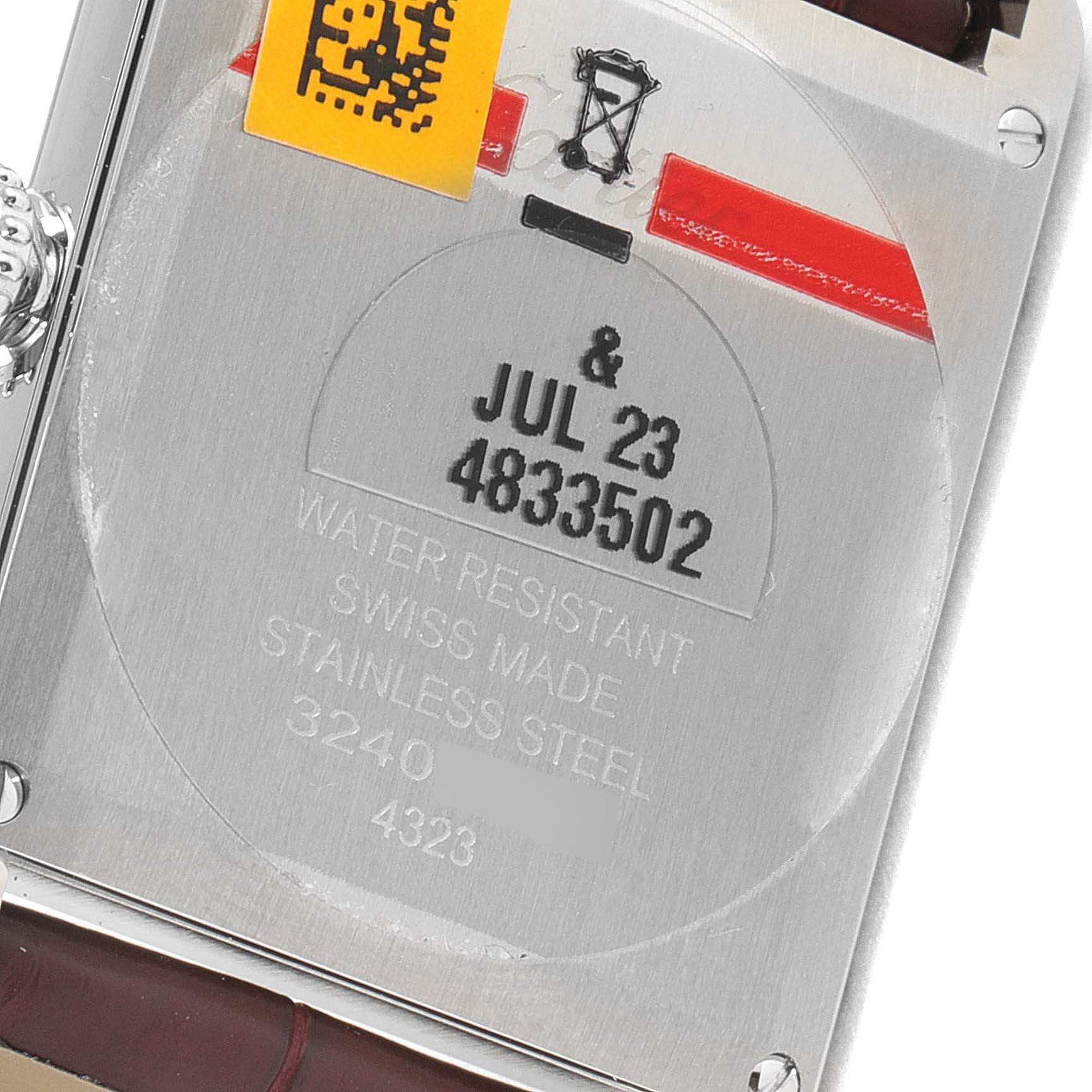 This image shows the back case and engravings of a Cartier Tank Must WSTA0054 Women's Stainless Steel Red Dial WSTA0054 Women's Stainless Steel Red Dial watch.