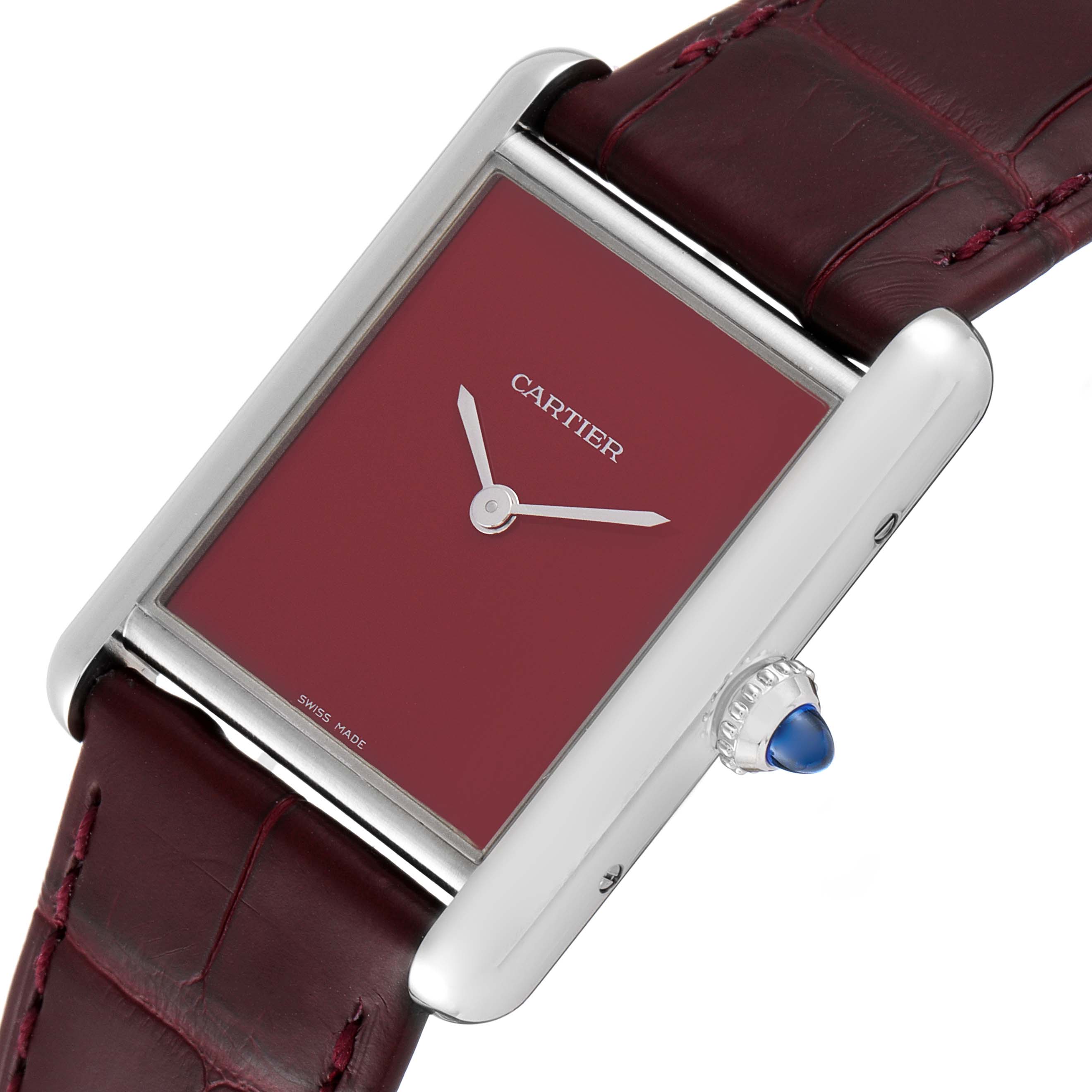 The image shows a close-up, angled view of the Cartier Tank Must WSTA0054 Women's Stainless Steel Red Dial WSTA0054 Women's Stainless Steel Red Dial watch, displaying its face, crown, and part of the strap.