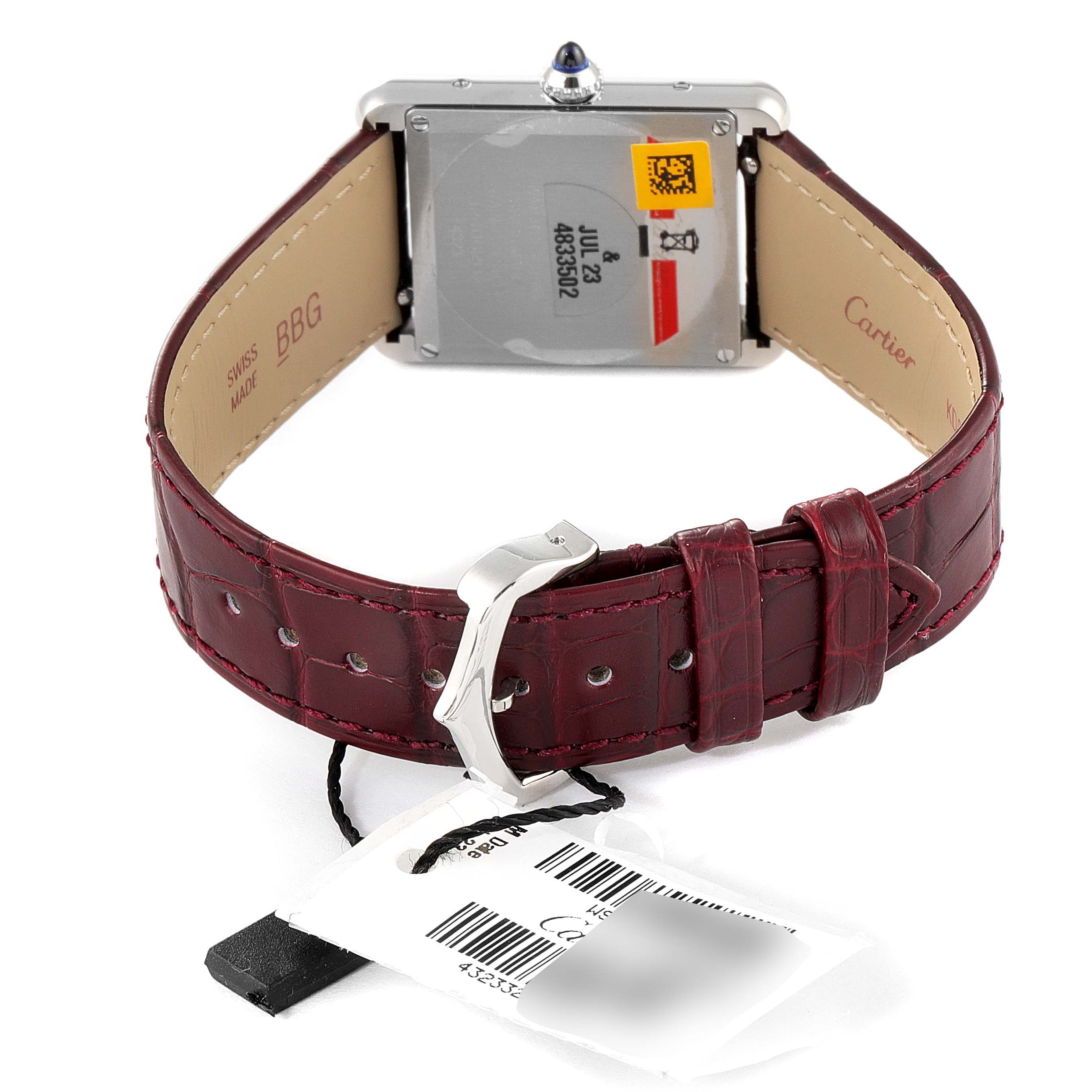 The image shows the back and strap of the Cartier Tank Must WSTA0054 Women's Stainless Steel Red Dial WSTA0054 Women's Stainless Steel Red Dial watch, with the buckle and tags visible.