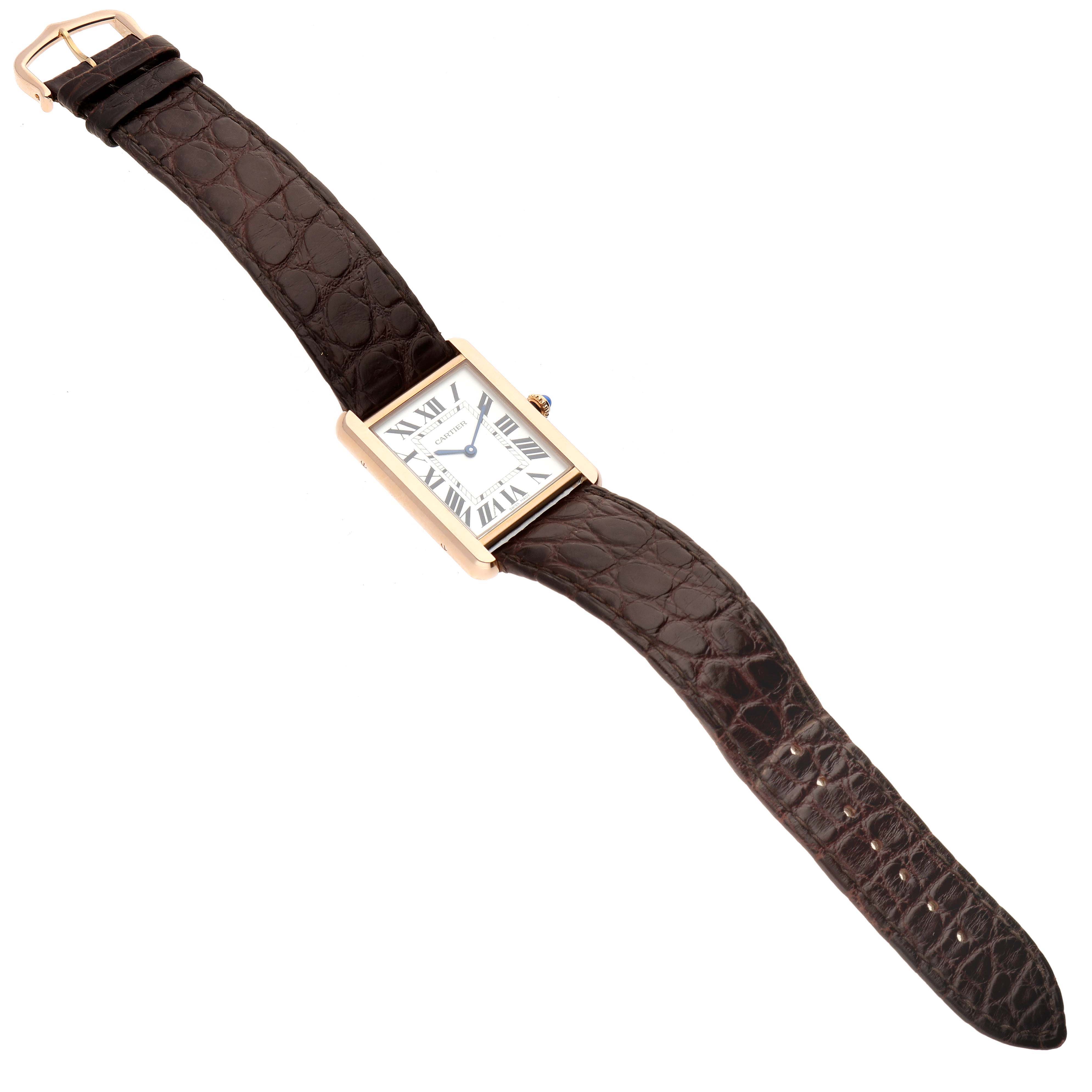 The Cartier Tank Solo W5200025 Men's Steel and Gold (two tone) Silver Dial W5200025 Men's Steel and Gold (two tone) Silver Dial watch is shown from a top-down angle, displaying its rectangular face and brown leather strap.