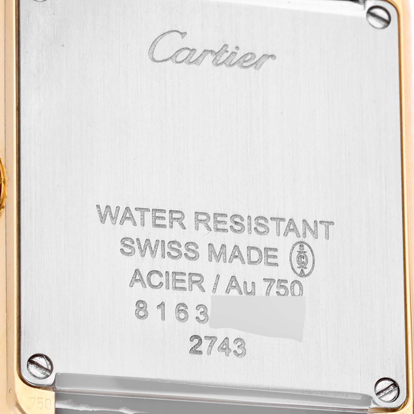 This image shows the back case of a Cartier Tank Solo W1018755 Women
s Steel and Gold (two tone) Silver Dial W1018755 Women
s Steel and Gold (two tone) Silver Dial watch, highlighting details like water resistance and materials used.