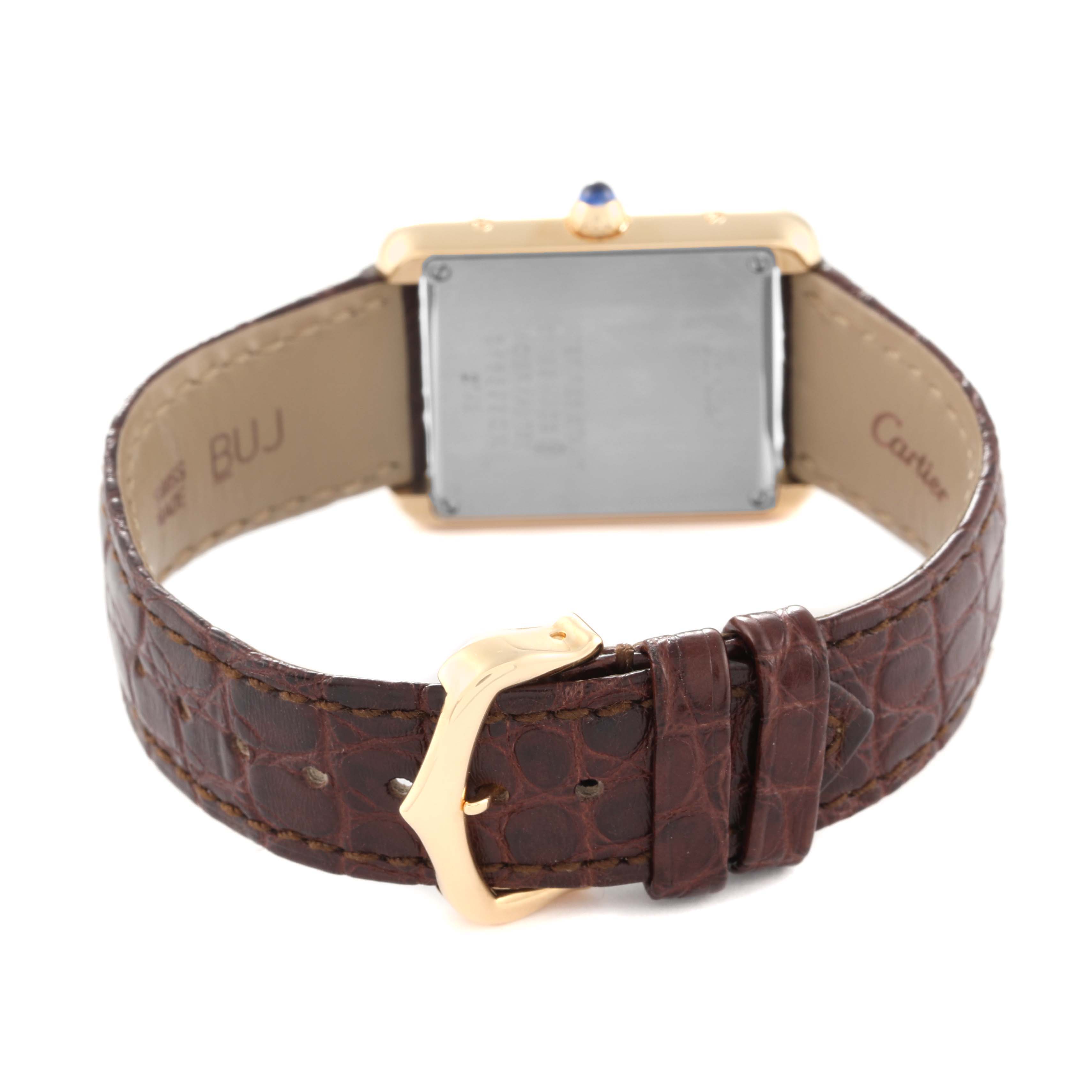 The image shows the back of a Cartier Tank Solo W1018755 Women
s Steel and Gold (two tone) Silver Dial W1018755 Women
s Steel and Gold (two tone) Silver Dial watch, displaying its leather strap and the buckle.