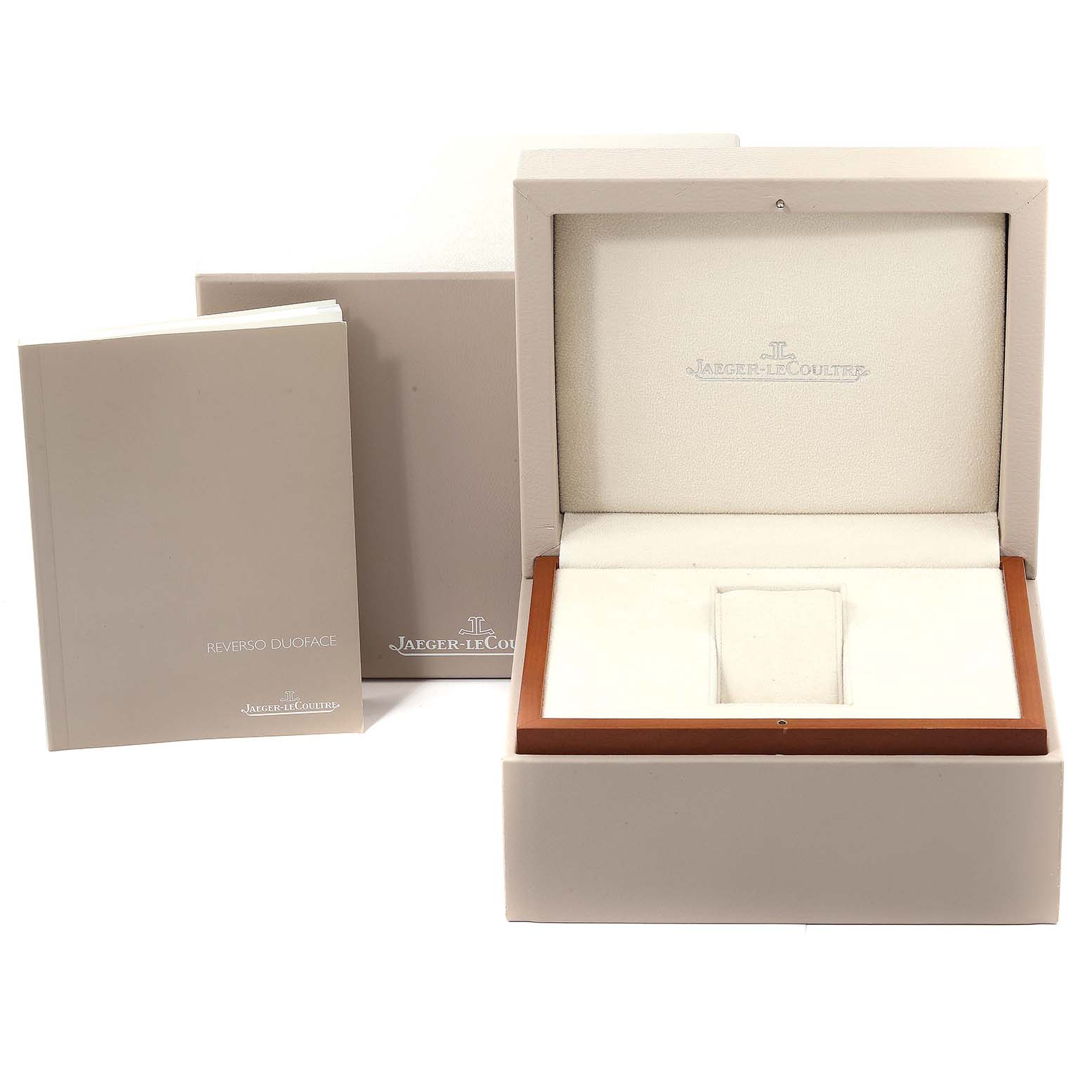 The image shows an open Jaeger LeCoultre Reverso Q2718410 Men's Stainless Steel Silver Dial Q2718410 Men's Stainless Steel Silver Dial watch box with its manuals placed beside it.