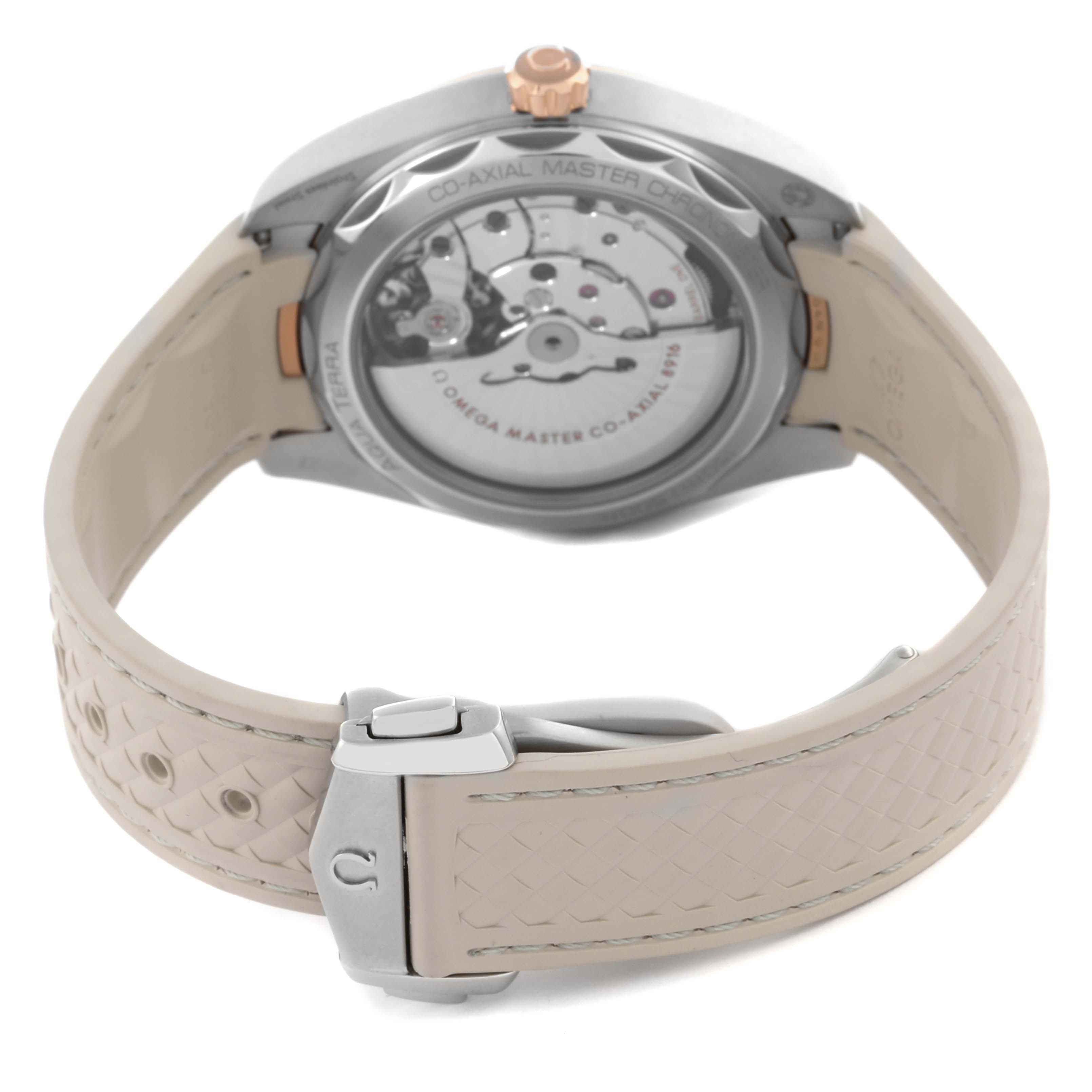 The image shows the back view of the Omega Aqua Terra 220.22.41.21.03.001 Men's Steel and Gold (two tone) Blue Dial 220.22.41.21.03.001 Men's Steel and Gold (two tone) Blue Dial watch, highlighting its open case back and beige strap with a clasp.