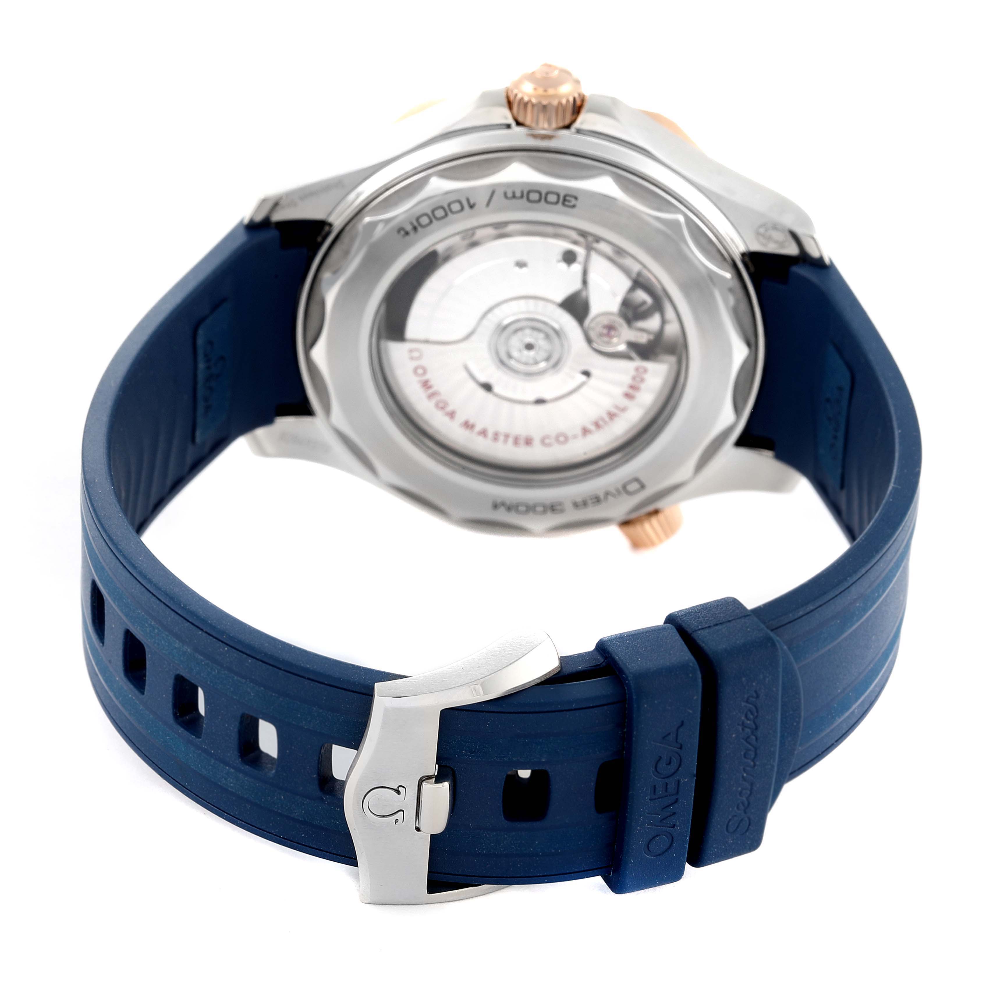 The image shows the back view of an Omega Seamaster 210.22.42.20.03.002 Men's Steel and Gold (two tone) Blue Dial 210.22.42.20.03.002 Men's Steel and Gold (two tone) Blue Dial watch, focusing on the case back and blue rubber strap with the clasp.