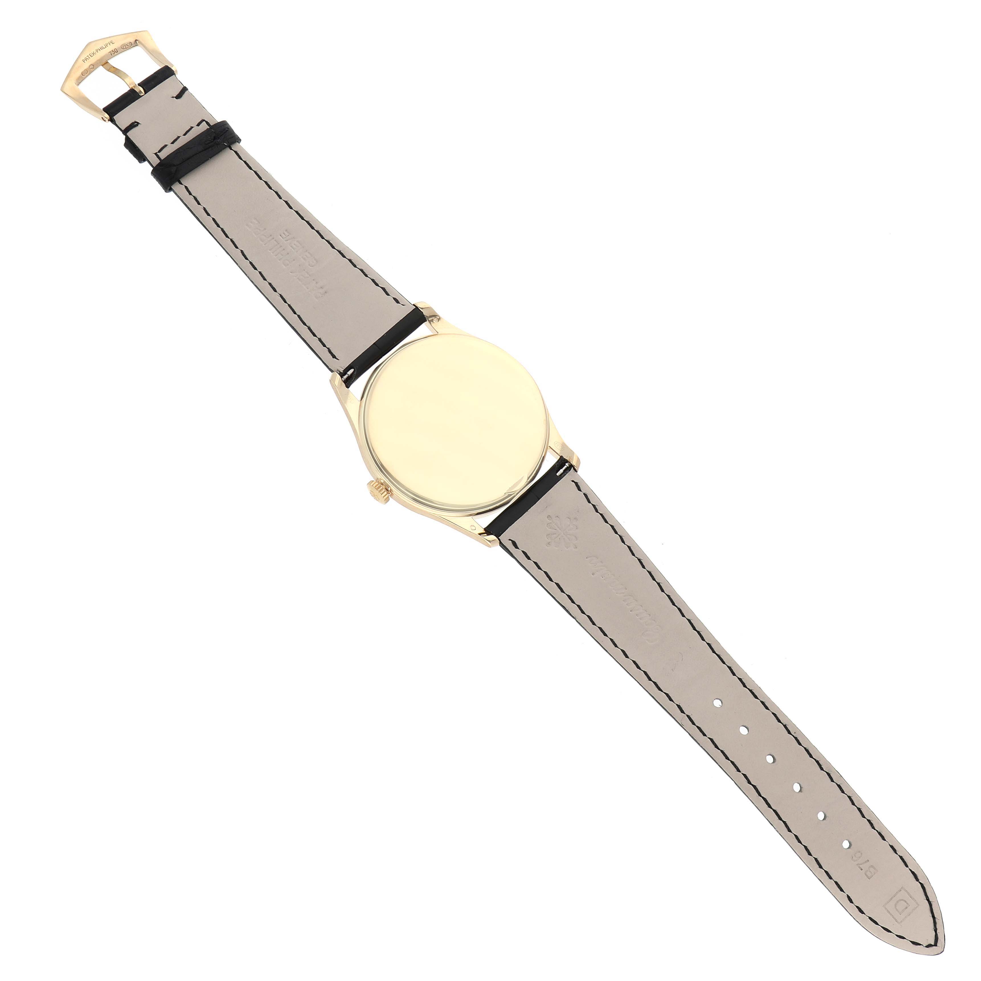 This image shows the back view of a Patek Philippe Calatrava 5196J Men's Yellow Gold Silver Dial 5196J Men's Yellow Gold Silver Dial watch, displaying its strap and case back.