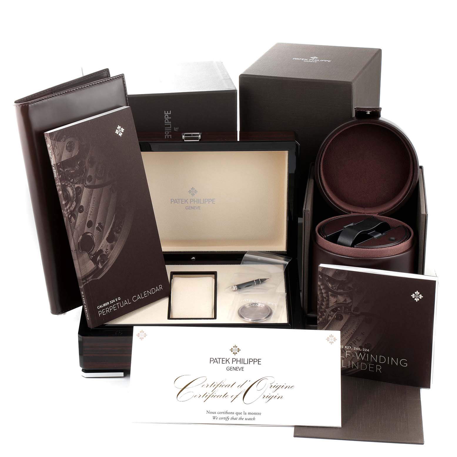 The image shows the packaging, books, and accessories of a Patek Philippe Complications 5320G-001 Men's White Gold Beige Dial 5320G-001 Men's White Gold Beige Dial watch, including manuals and a certificate.