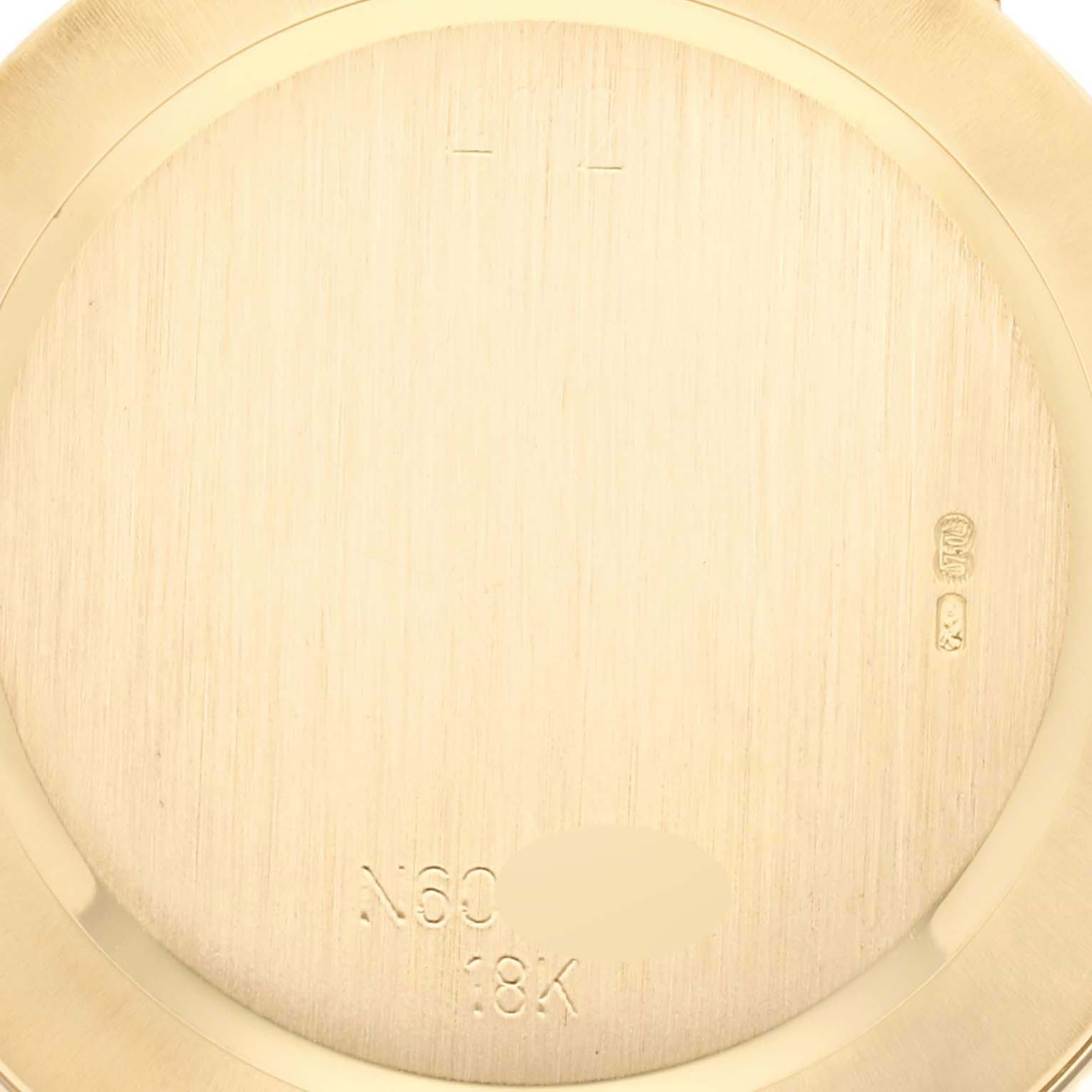 The image shows the case back of a Rolex Cellini 4112 Men's Yellow Gold Champagne Dial 4112 Men's Yellow Gold Champagne Dial watch, revealing its engravings and inscriptions.