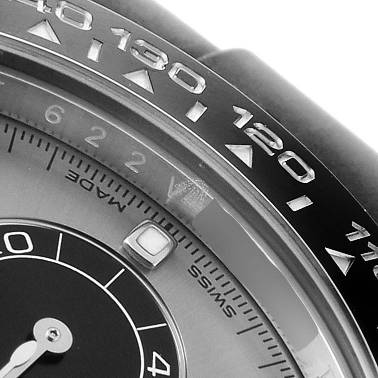 The close-up image shows the bezel, part of the dial, and a sub-dial of a Rolex Daytona 116519 Men's White Gold Grey Dial 116519 Men's White Gold Grey Dial watch.