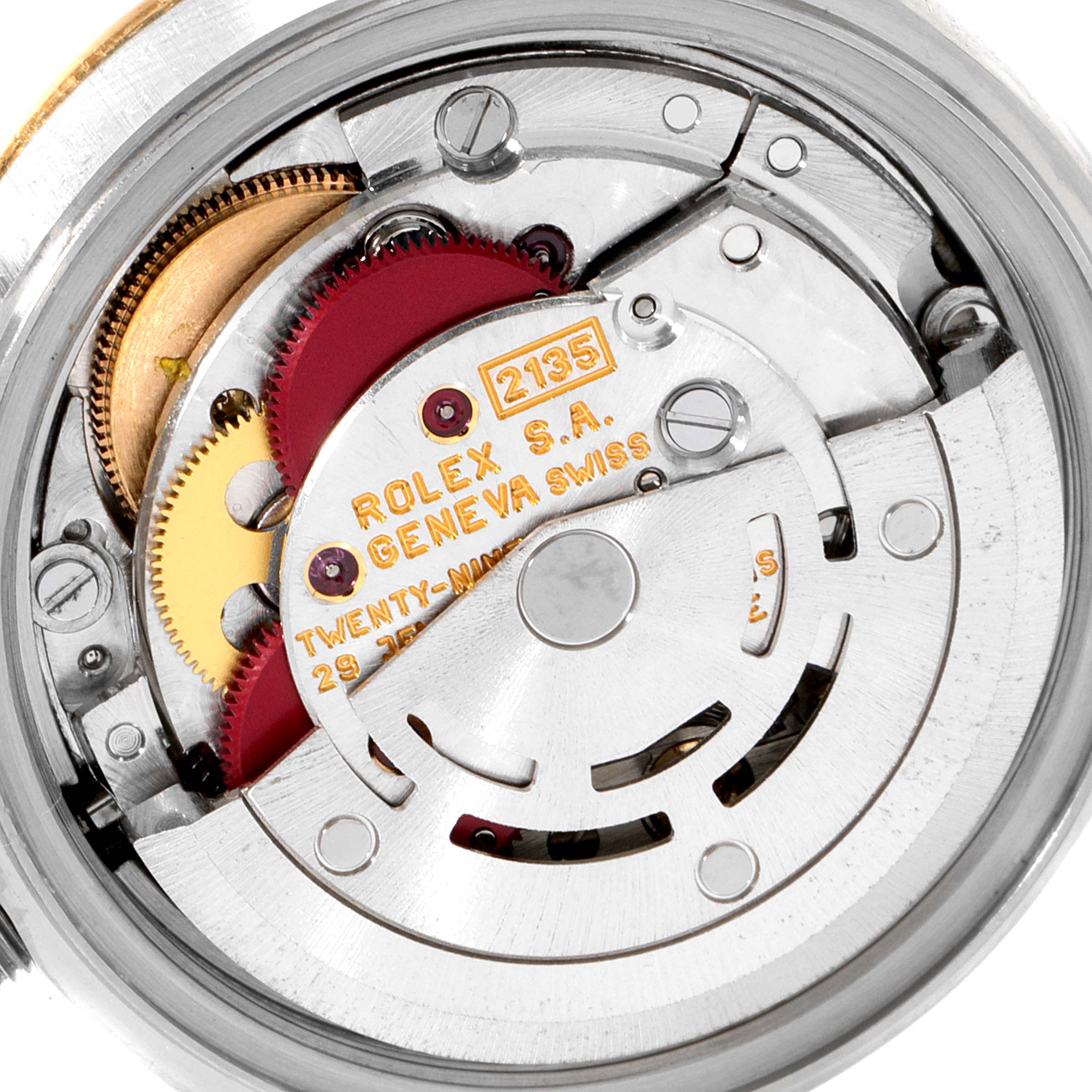 This close-up image shows the internal movement mechanism of a Rolex Datejust 69173 Women
s Steel and Gold (two tone) Champagne Dial 69173 Women
s Steel and Gold (two tone) Champagne Dial watch, highlighting gears and inscriptions.