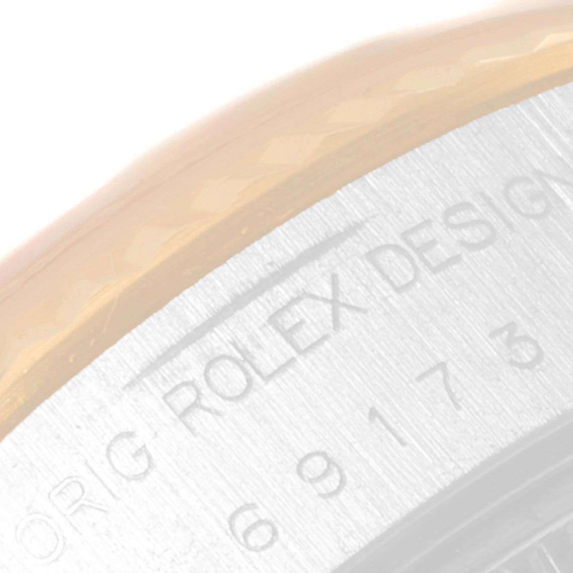 This image shows a close-up of the side engraving on the bezel of a Rolex Datejust 69173 Women
s Steel and Gold (two tone) Champagne Dial 69173 Women
s Steel and Gold (two tone) Champagne Dial watch.