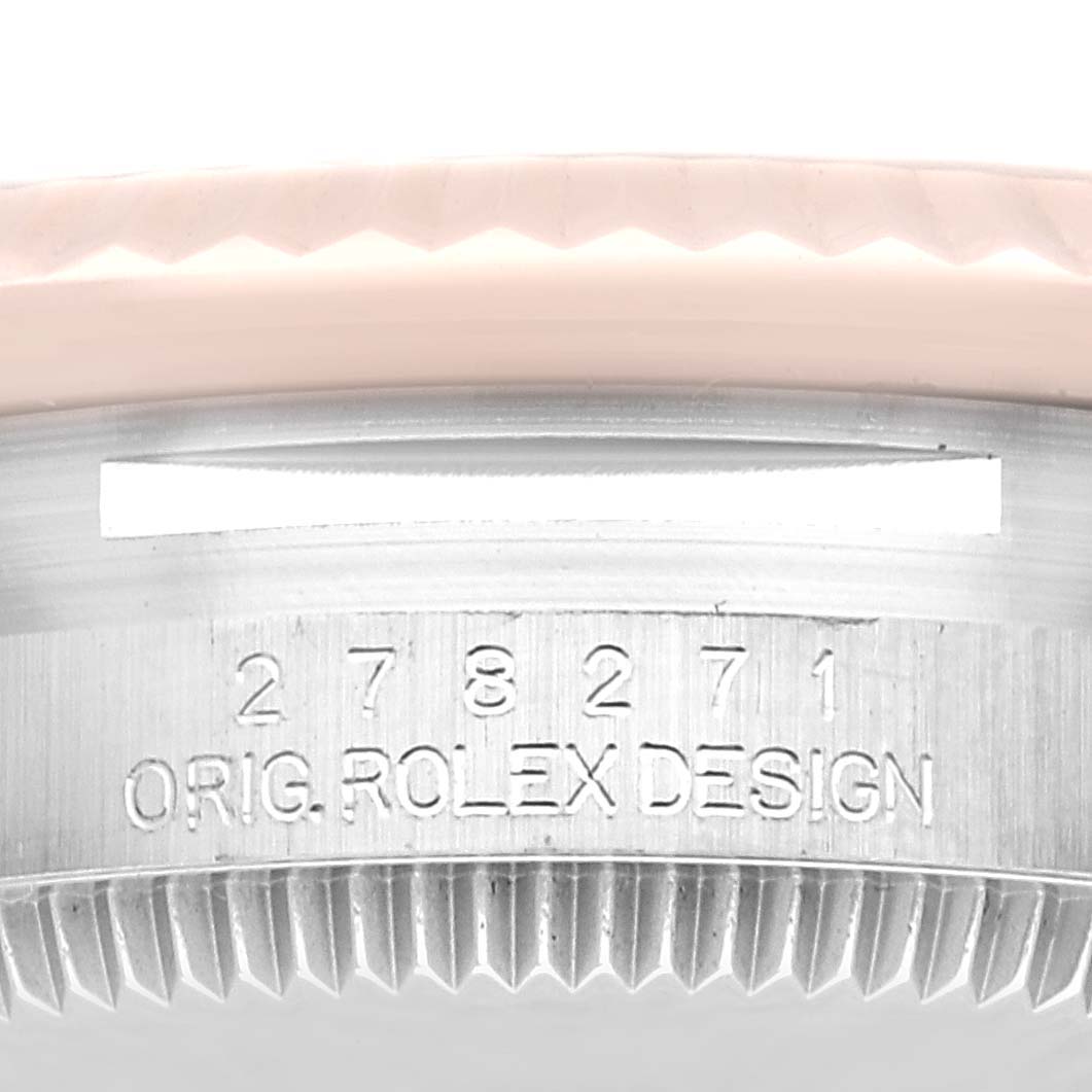 This image shows a close-up of the side view of a Rolex Mid-Size 278271 Women's Steel and Gold (two tone) Grey Dial 278271 Women's Steel and Gold (two tone) Grey Dial watch case with the serial number engraved.