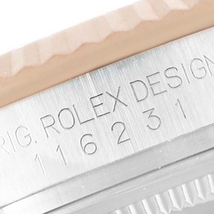 This image shows the side engraving and fluted bezel detail of the Rolex Datejust 116231 Men's Steel and Gold (two tone) Black Dial 116231 Men's Steel and Gold (two tone) Black Dial watch.