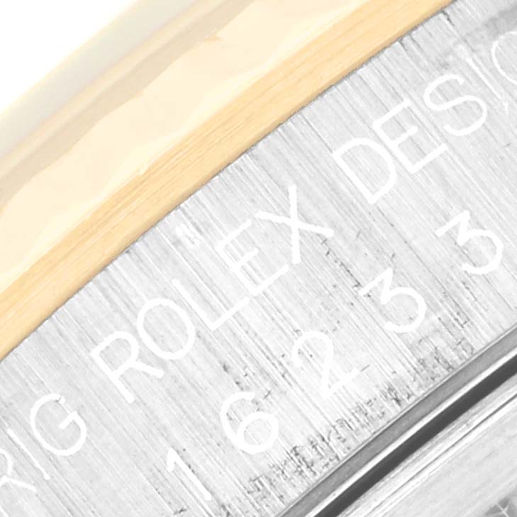 A close-up of the side engraving on the bezel of a Rolex Datejust 16233 Men's Steel and Gold (two tone) Black Dial 16233 Men's Steel and Gold (two tone) Black Dial watch is shown.