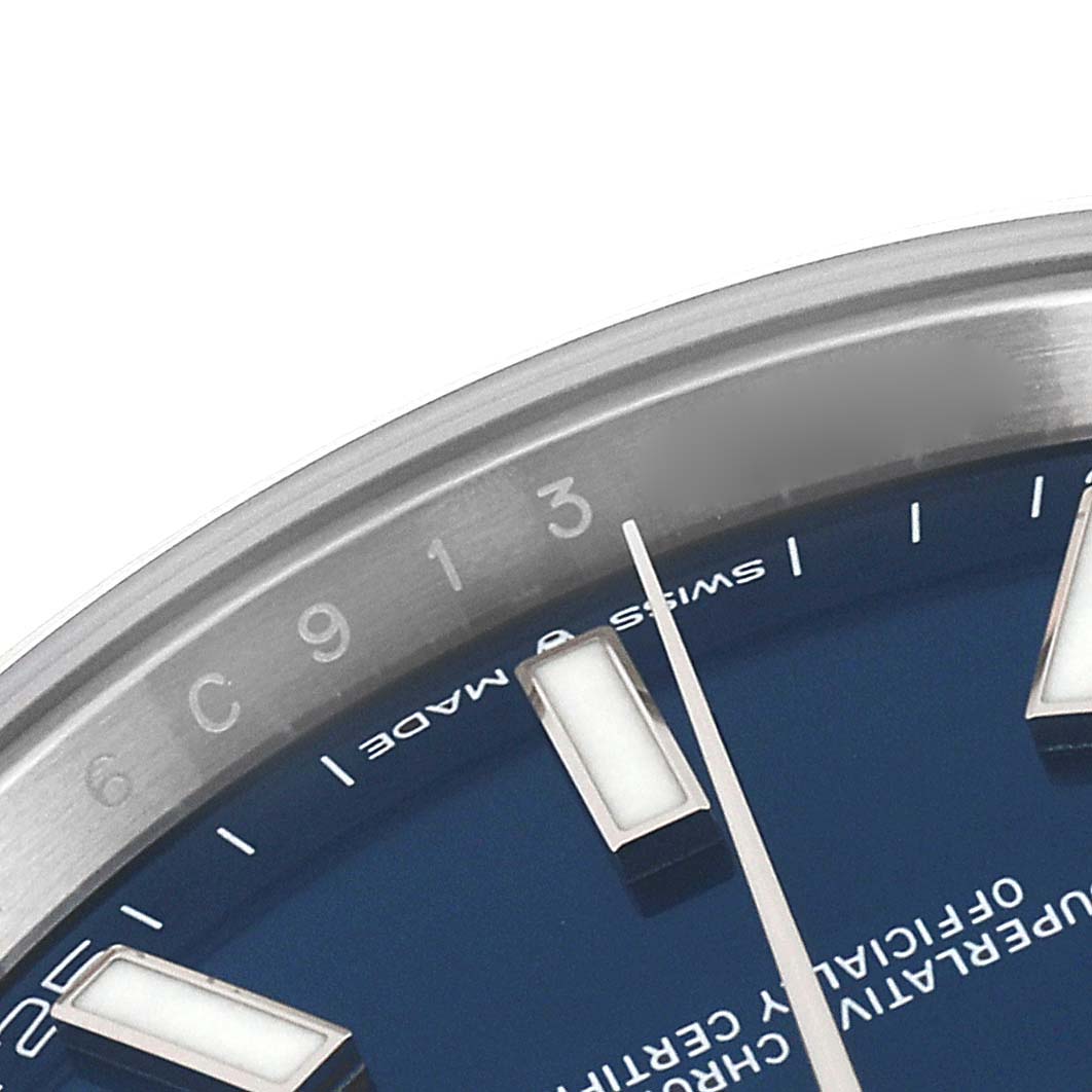 The image shows a close-up of the Rolex Datejust 41 126300 Men's Stainless Steel Blue Dial 126300 Men's Stainless Steel Blue Dial watch dial, focusing on the bezel, hour markers, and part of a hand.