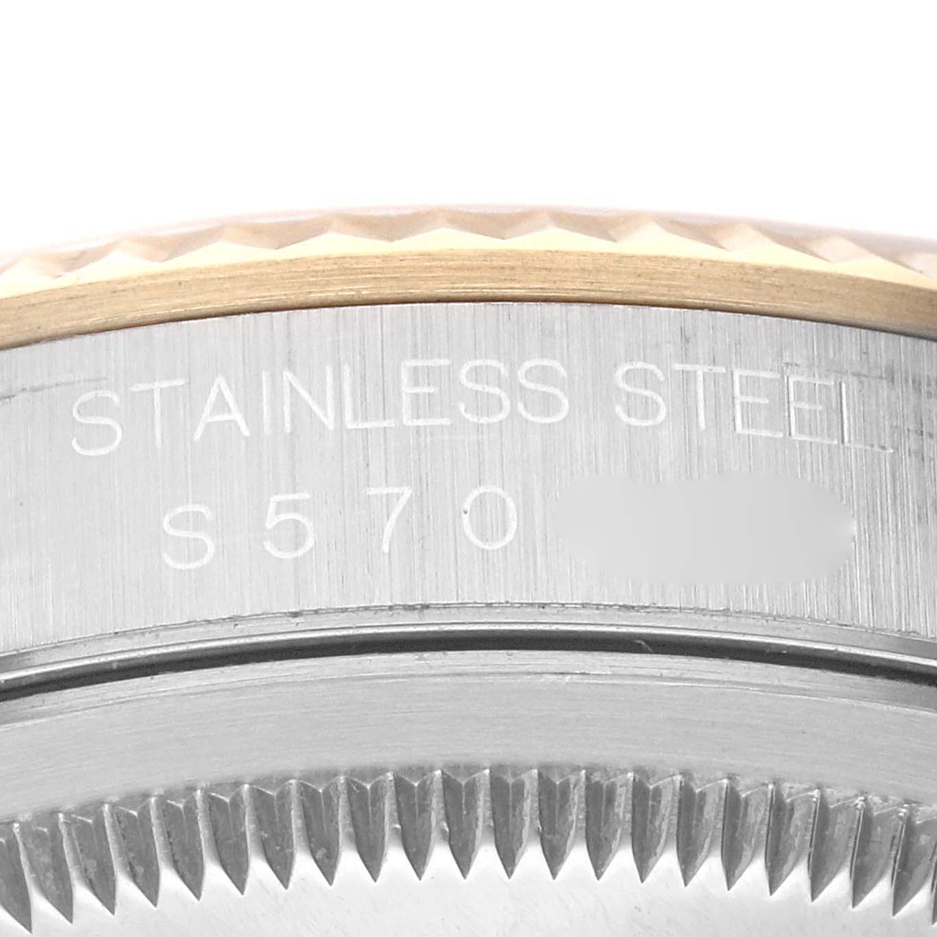 This image shows a close-up of the stainless steel part of a Rolex Datejust 16233 Men's Steel and Gold (two tone) Champagne Dial 16233 Men's Steel and Gold (two tone) Champagne Dial watch, focusing on the model number and fluted bezel.