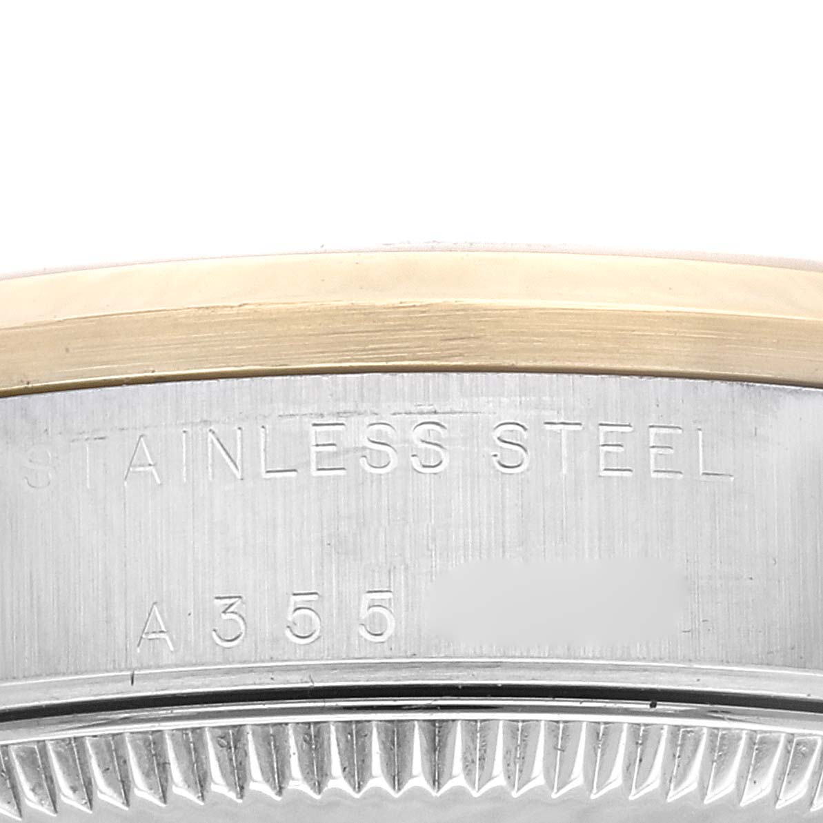 The image shows a close-up of the side of a Mid-Size Rolex watch case, displaying the "Stainless Steel" engraving and serial number.