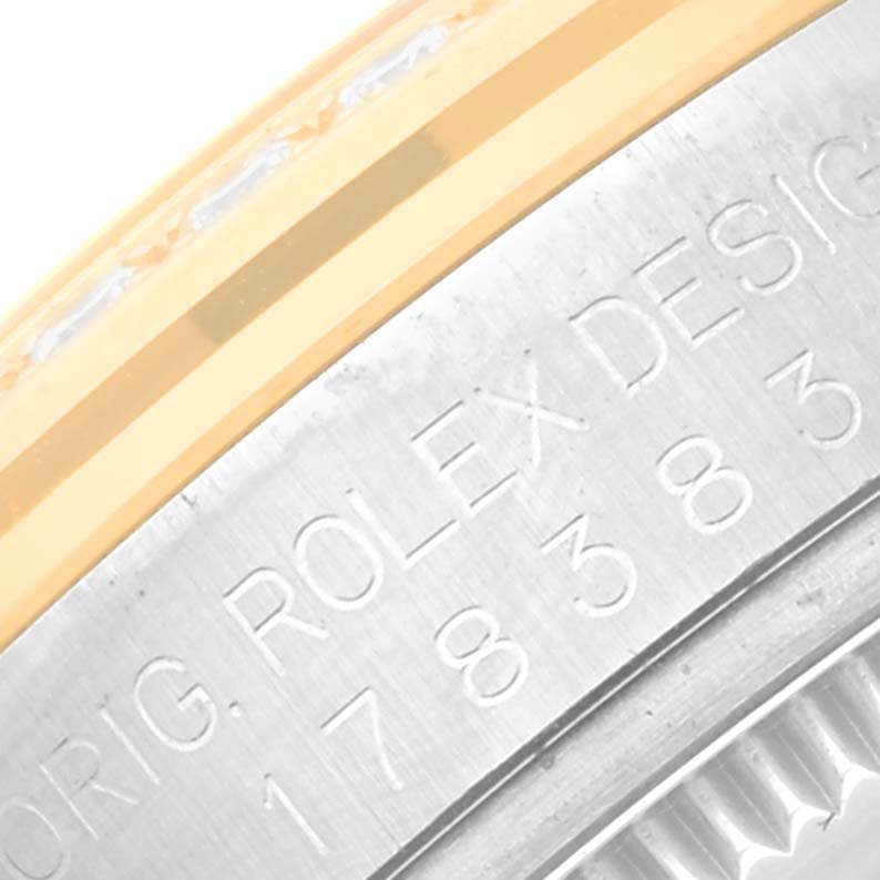 This is a close-up of the bezel and engraved casing of a Mid-Size Rolex watch, showing the brand and design details.