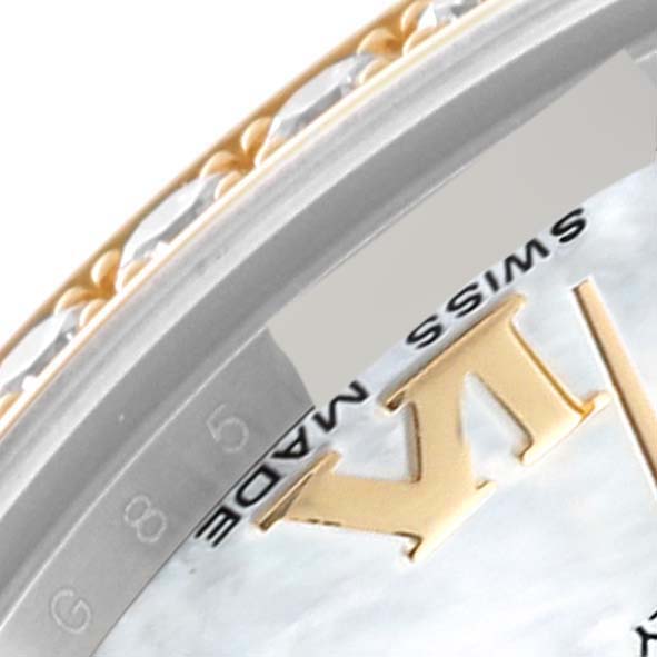The image shows a close-up of the bezel and part of the dial of a Mid-Size Rolex watch.